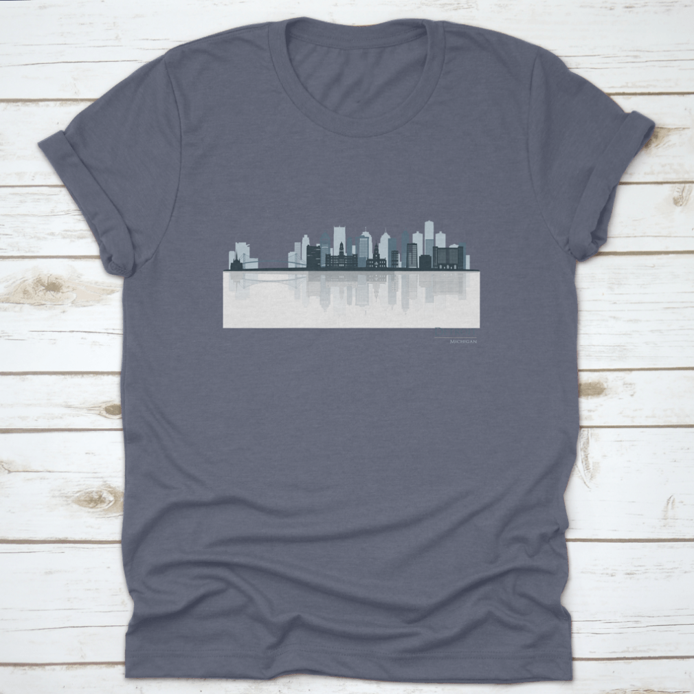 A stylish t-shirt featuring the Detroit skyline silhouette with reflection, showcasing iconic buildings in a modern design.