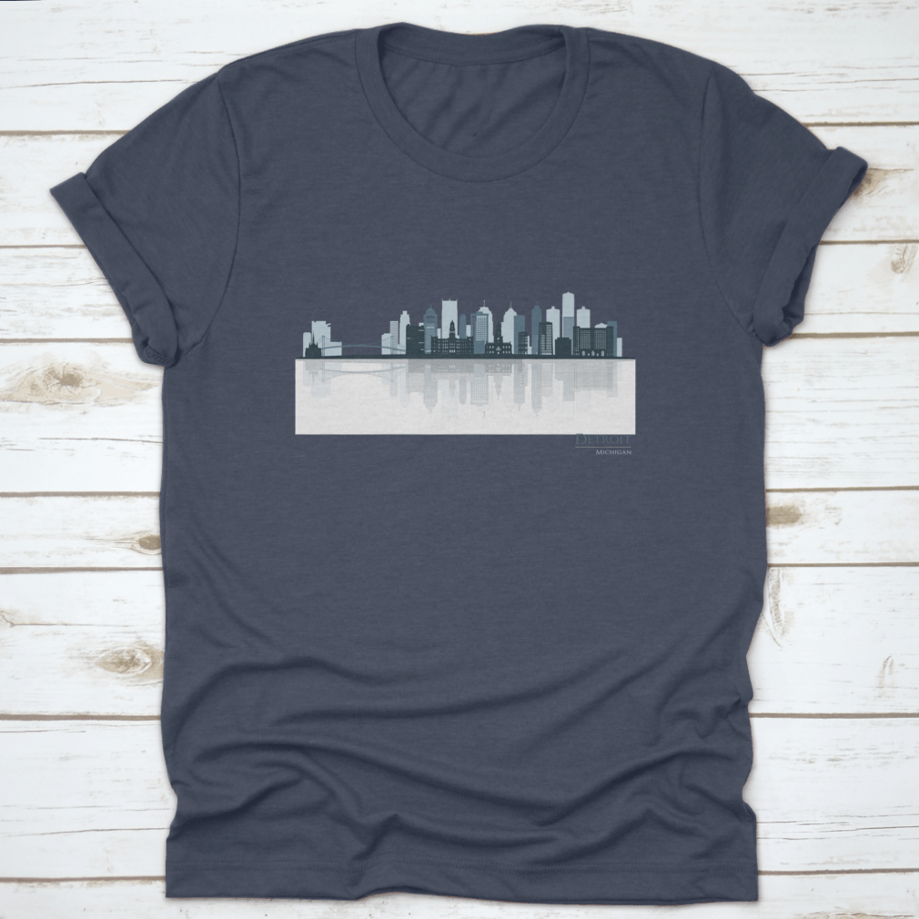 A stylish t-shirt featuring the Detroit skyline silhouette with reflection, showcasing iconic buildings in a modern design.
