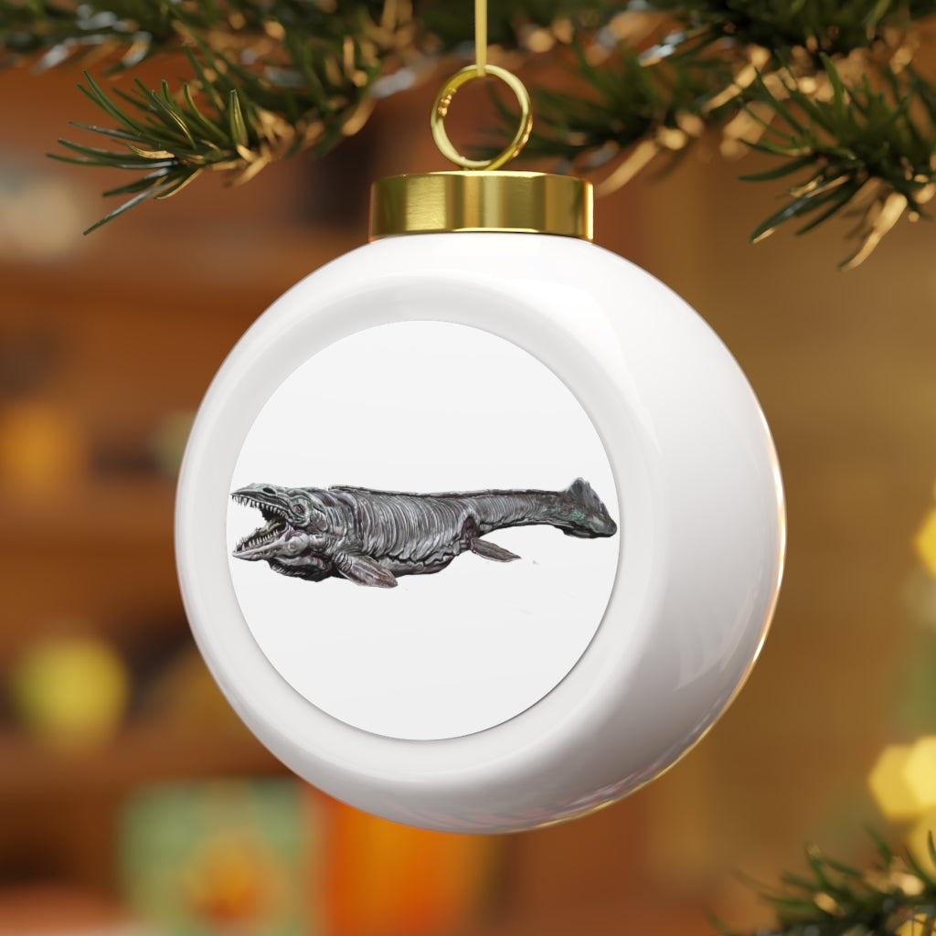 A 3-inch glossy Christmas ball ornament featuring a whimsical Dino Sea Creature design, complete with a gold ribbon for hanging.