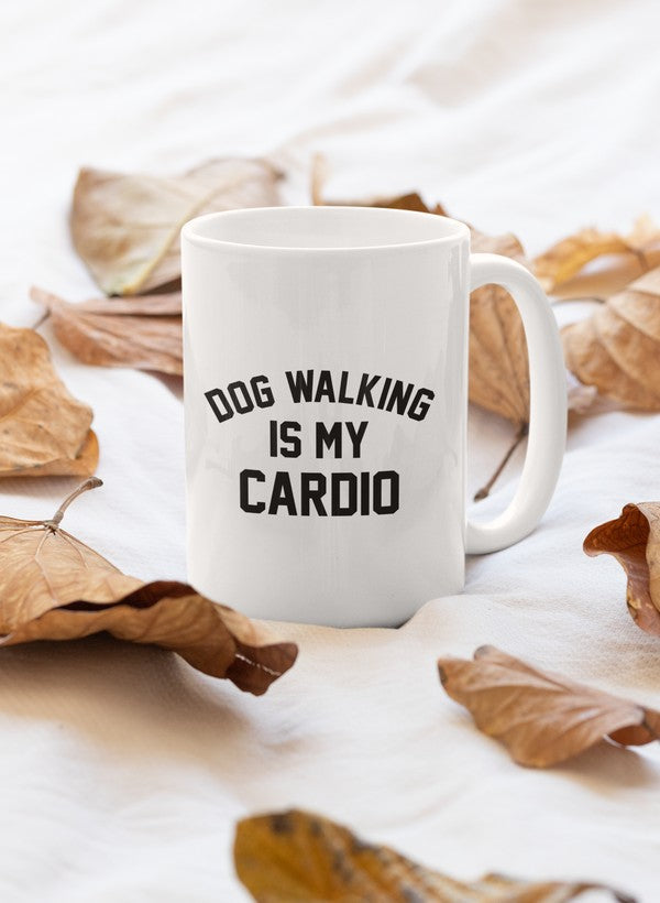 A stylish white ceramic mug with the phrase 'Dog Walking Is My Cardio' printed in bold letters, featuring a sturdy handle and glossy finish.