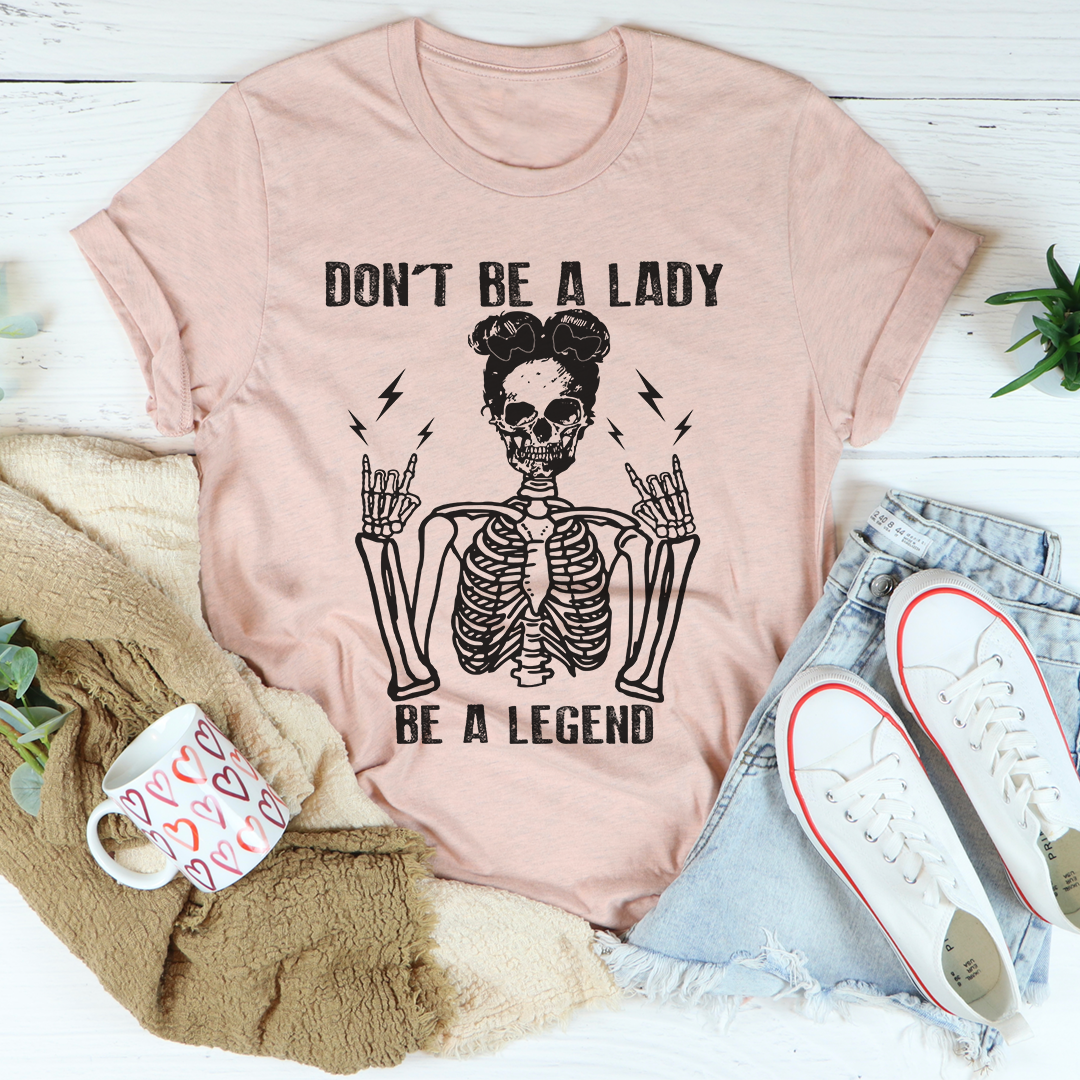 A stylish black t-shirt with the phrase 'Don't Be A Lady Be A Legend' printed in bold letters, showcasing its comfortable fit and durable design.