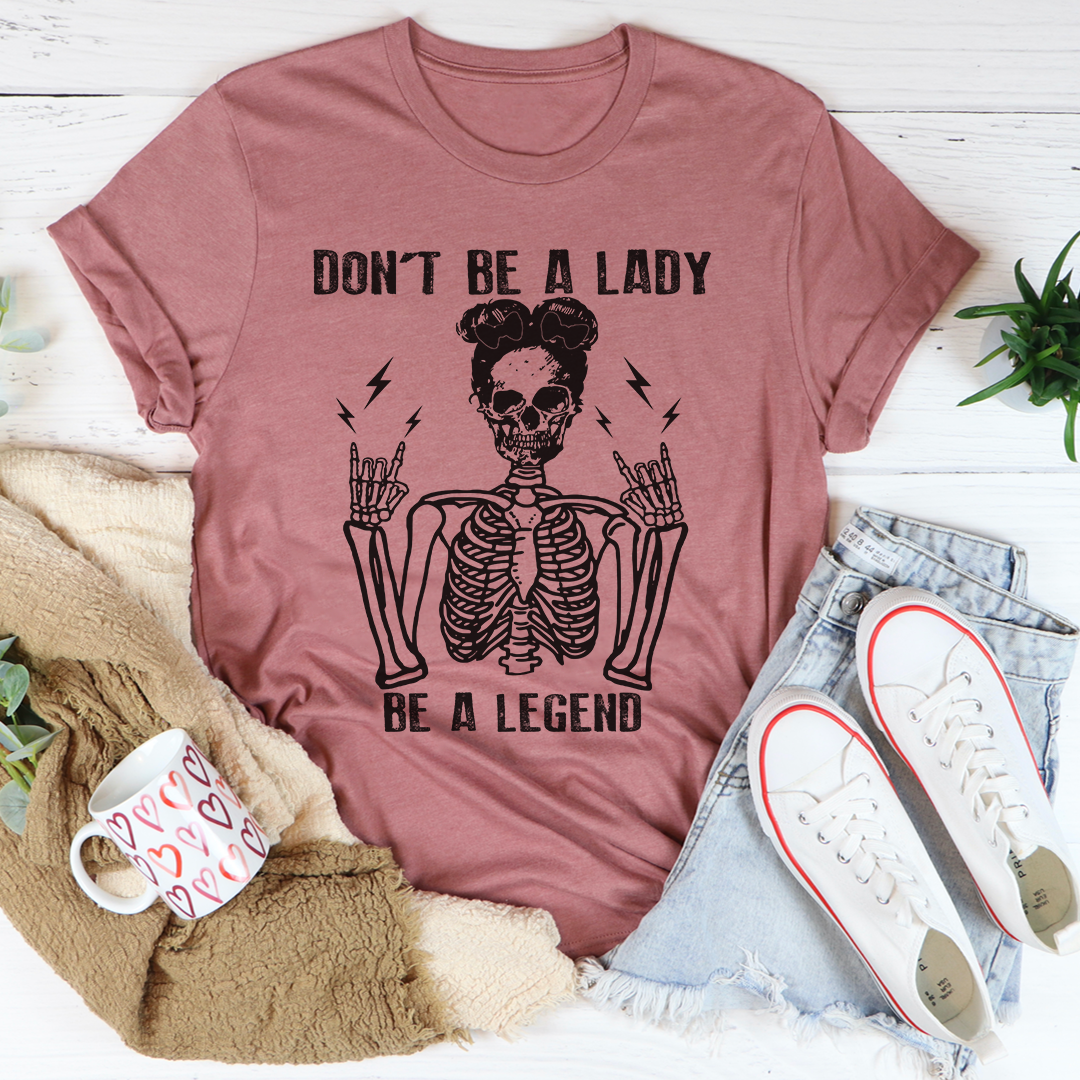 A stylish black t-shirt with the phrase 'Don't Be A Lady Be A Legend' printed in bold letters, showcasing its comfortable fit and durable design.