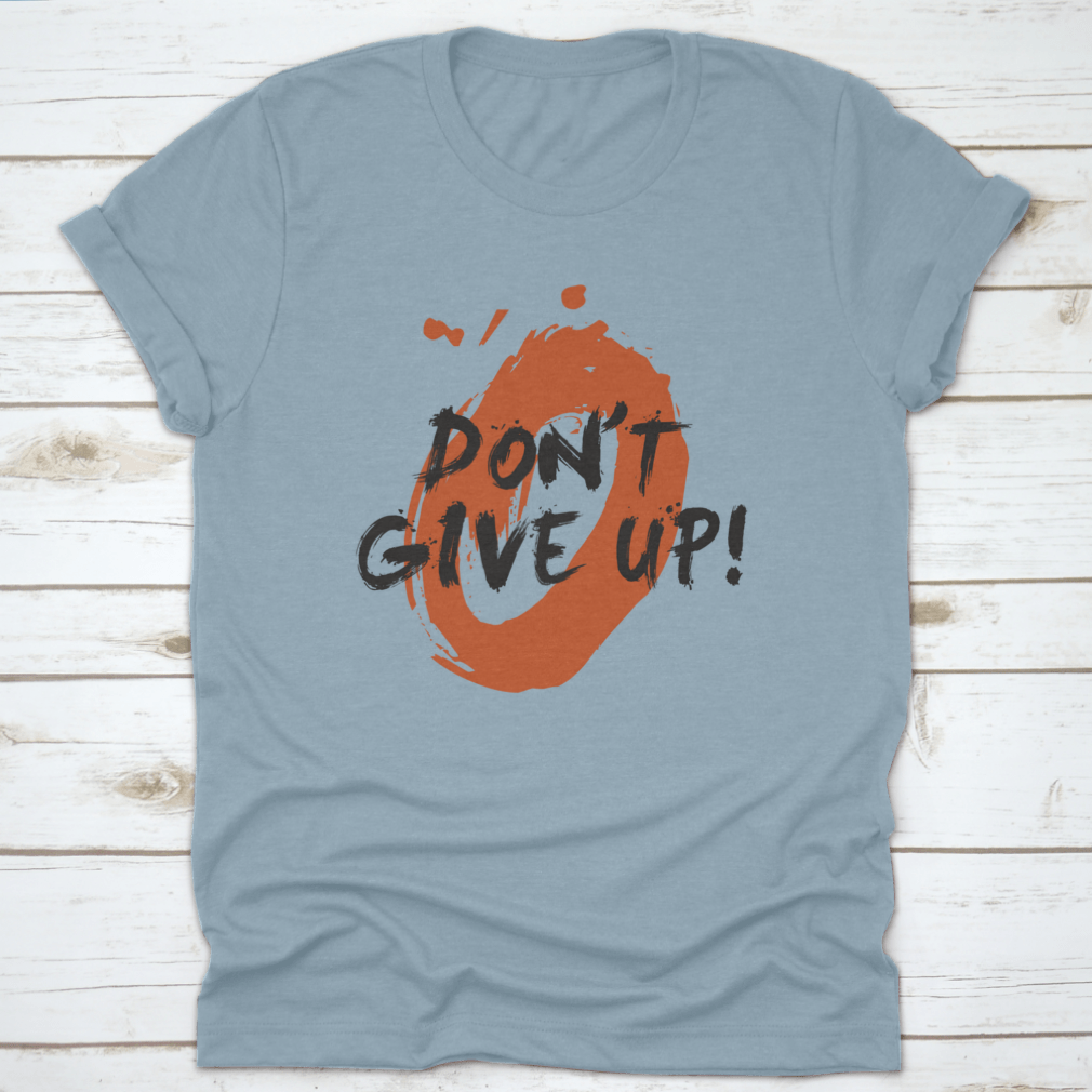 A stylish t-shirt featuring a motivational 'Don't Give Up!' brush lettering vector illustration design, made from high-quality cotton.