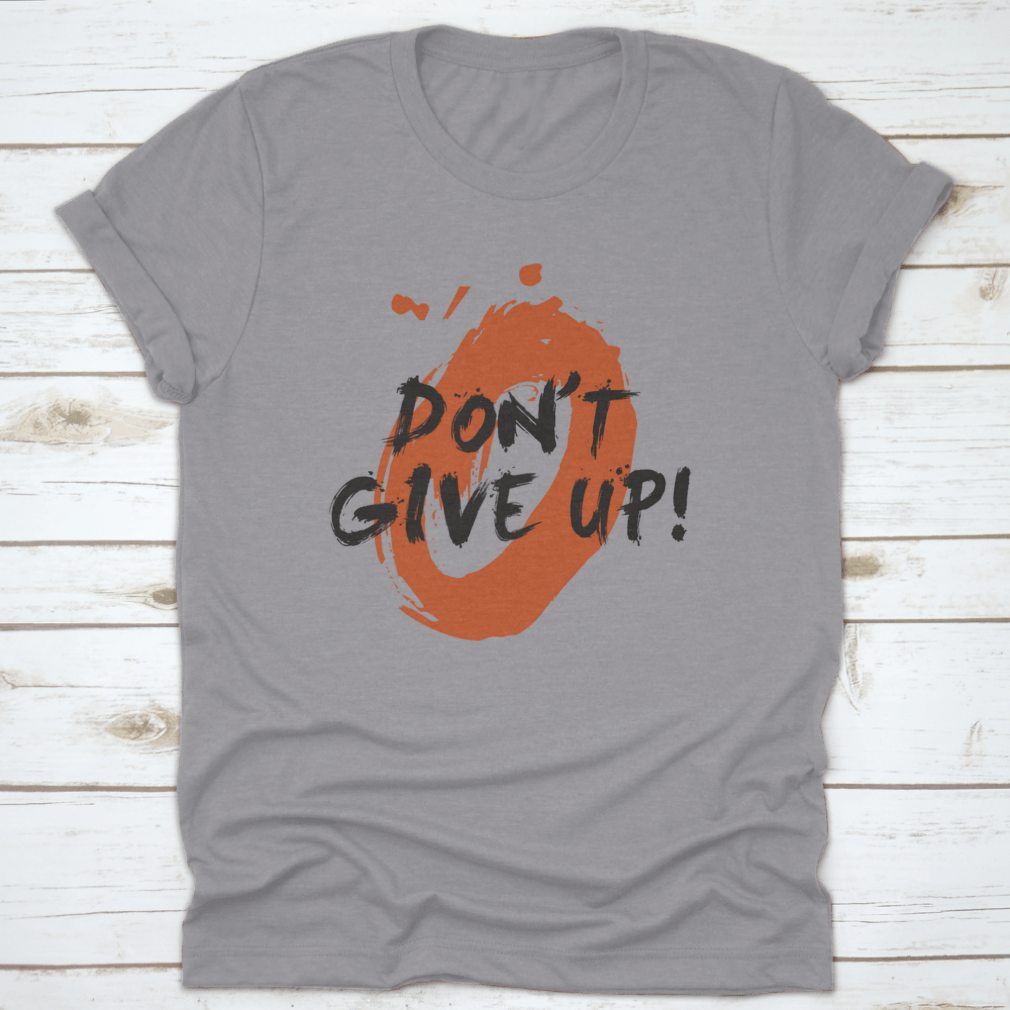 A stylish t-shirt featuring a motivational 'Don't Give Up!' brush lettering vector illustration design, made from high-quality cotton.