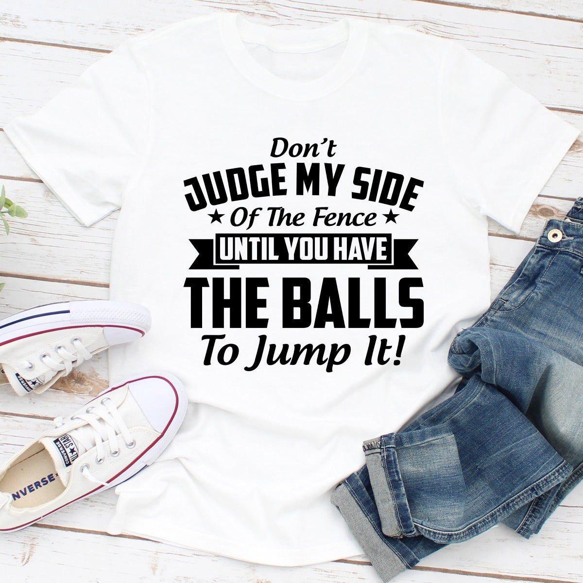 A stylish Don't Judge My Side Of The Fence T-Shirt made of soft cotton, featuring a humorous phrase printed on the front.
