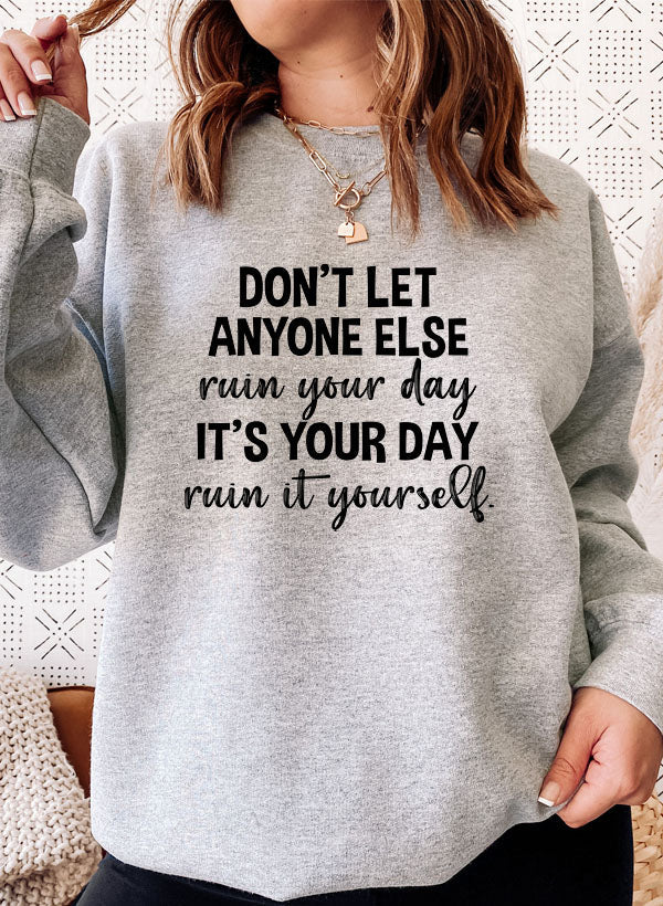 Cozy 'Don't Let Anyone Else Ruin Your Day' sweatshirt featuring a unique artistic design, perfect for casual wear.