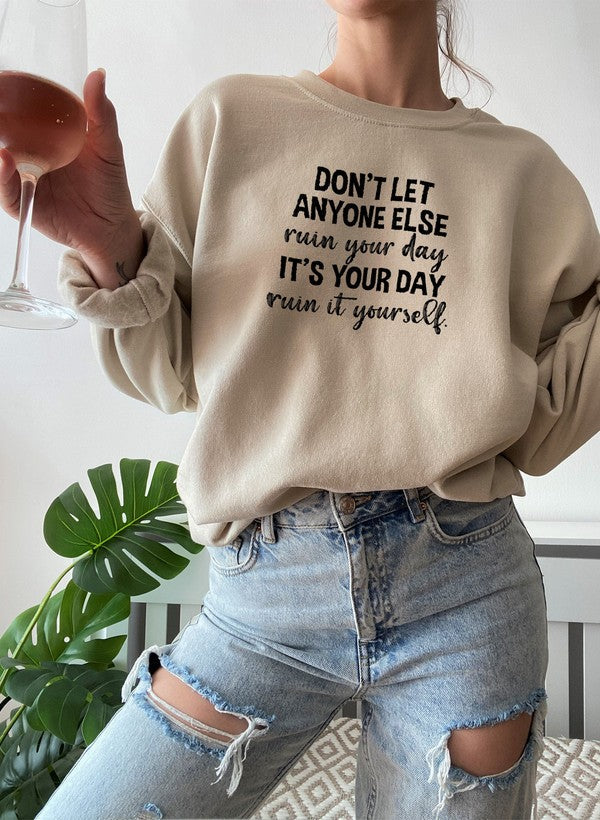 Cozy 'Don't Let Anyone Else Ruin Your Day' sweatshirt featuring a unique artistic design, perfect for casual wear.