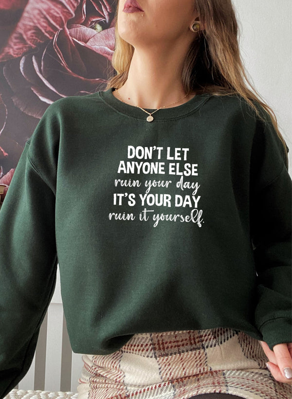 Cozy 'Don't Let Anyone Else Ruin Your Day' sweatshirt featuring a unique artistic design, perfect for casual wear.