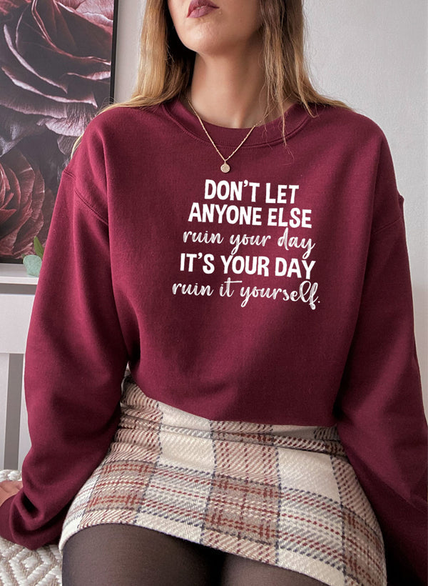 Cozy 'Don't Let Anyone Else Ruin Your Day' sweatshirt featuring a unique artistic design, perfect for casual wear.