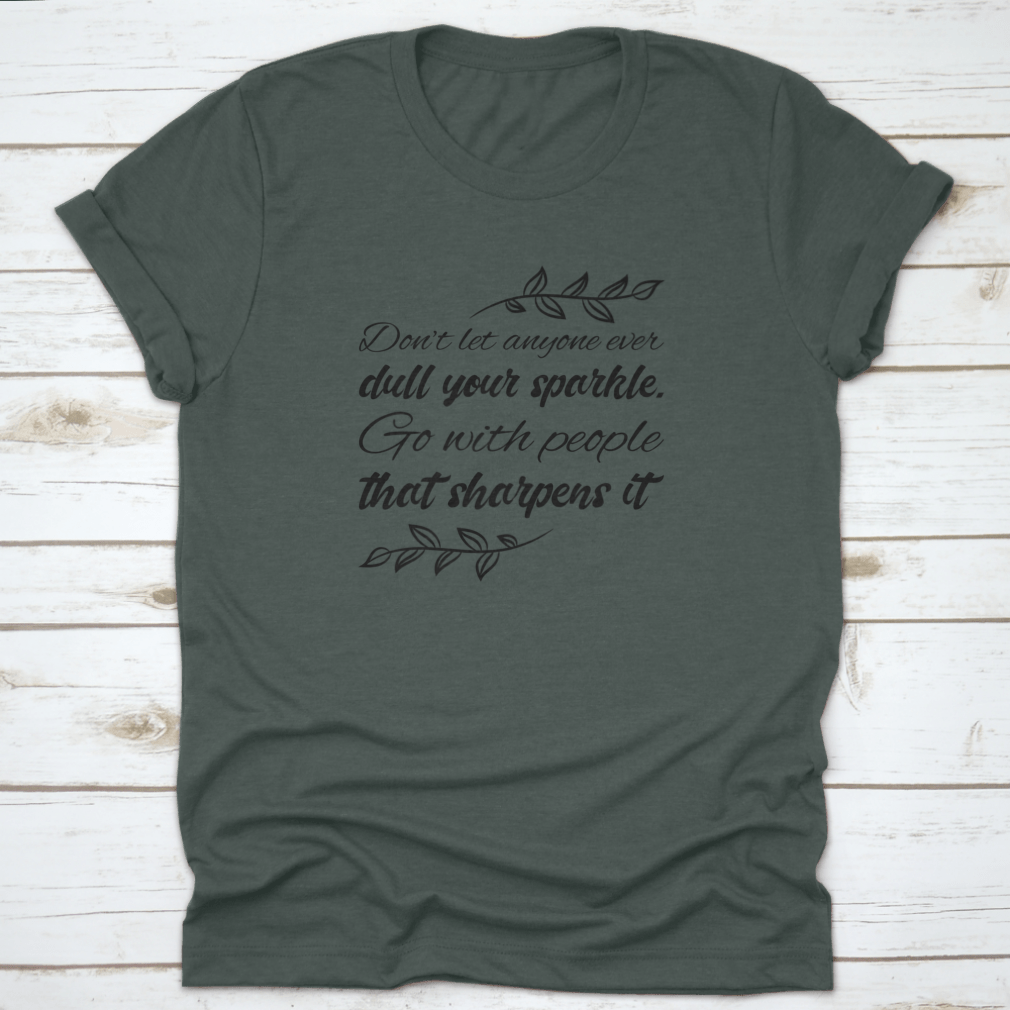 A stylish t-shirt featuring the quote 'Don’t Let Anyone Dull Your Sparkle' in a vibrant design, made from 100% cotton.