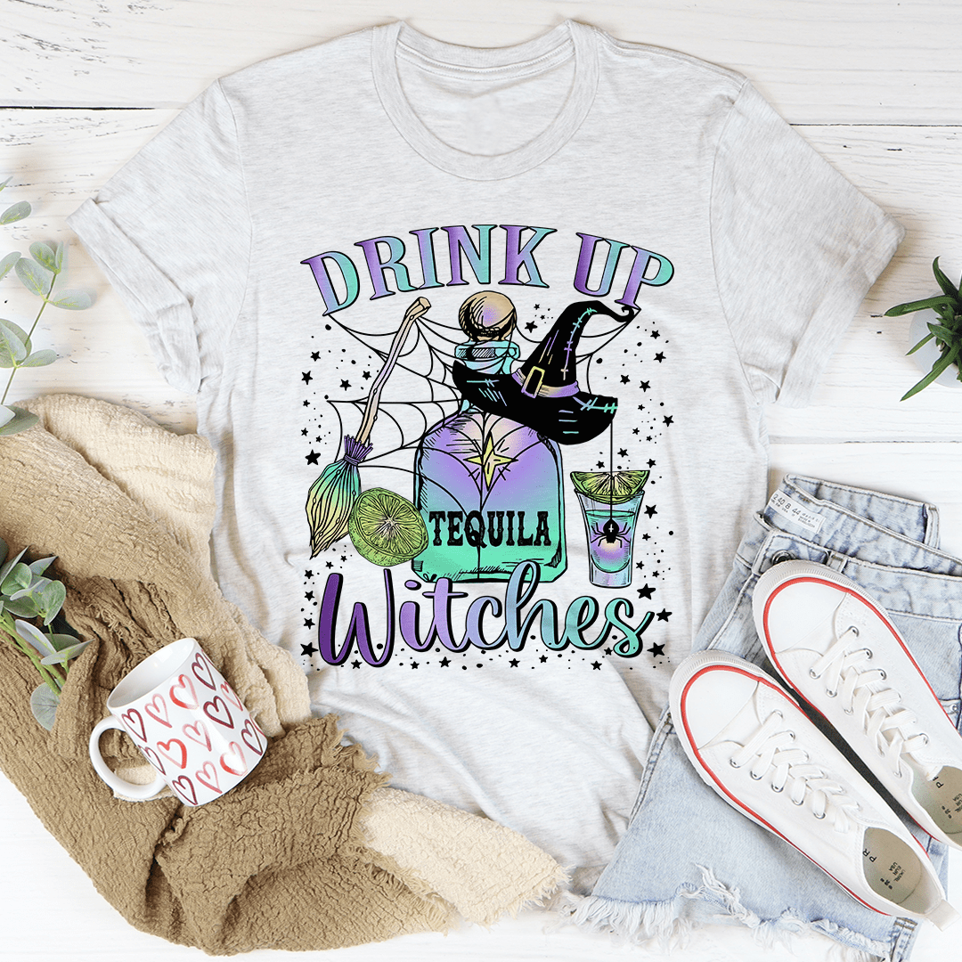 A stylish Drink Up Witches Tequila Tee featuring vibrant Halloween-themed graphics, made from 100% soft cotton for comfort.