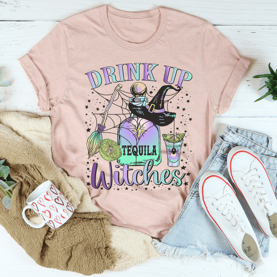 A stylish Drink Up Witches Tequila Tee featuring vibrant Halloween-themed graphics, made from 100% soft cotton for comfort.