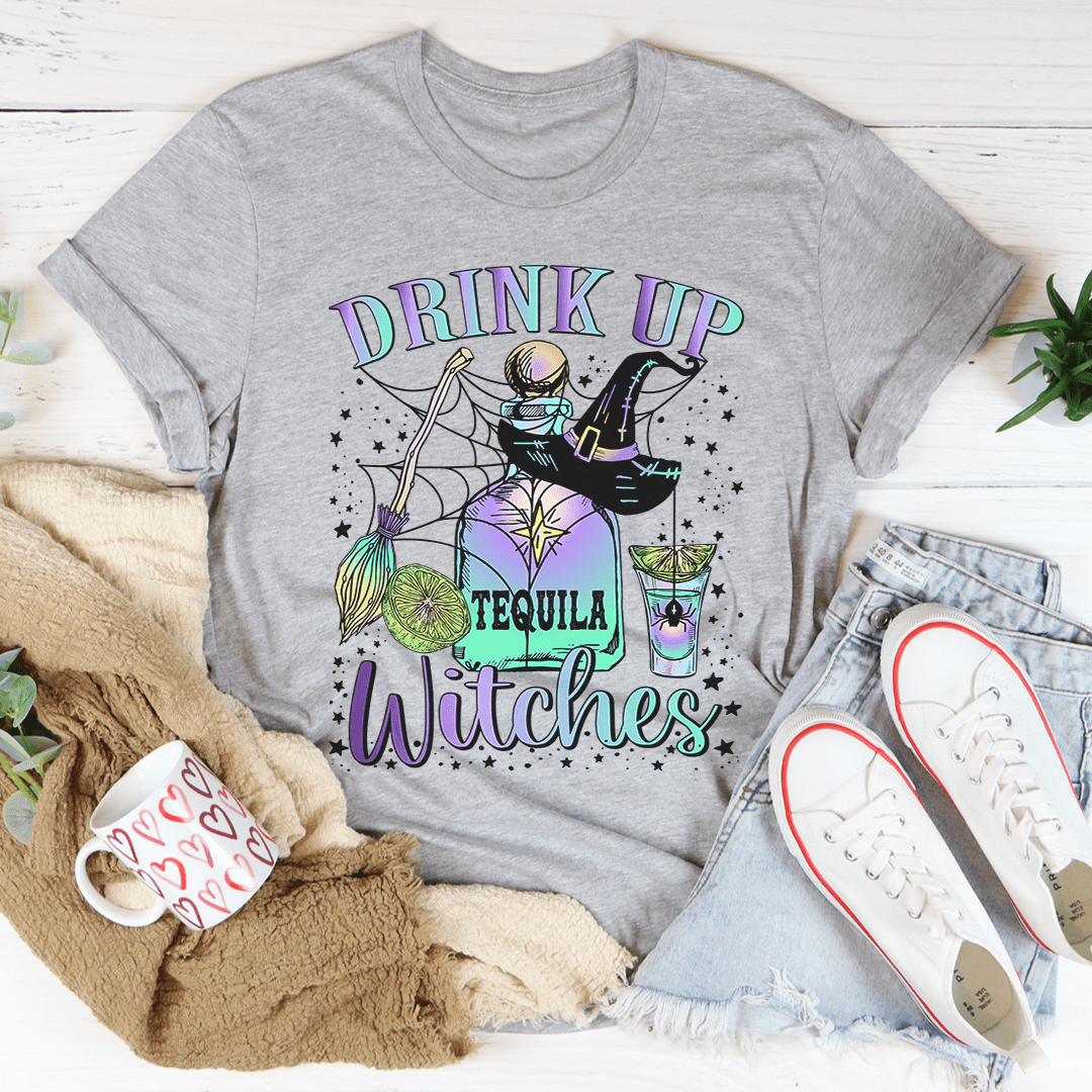 A stylish Drink Up Witches Tequila Tee featuring vibrant Halloween-themed graphics, made from 100% soft cotton for comfort.