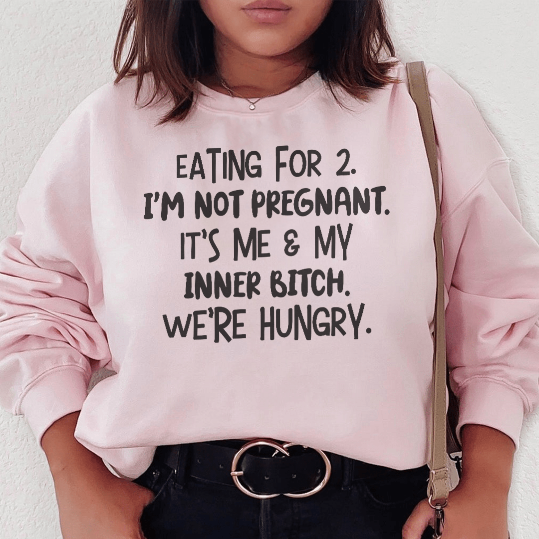 A cozy 'Eating For Two' sweatshirt featuring a unique design by top artists, made from a warm cotton/poly fleece blend.