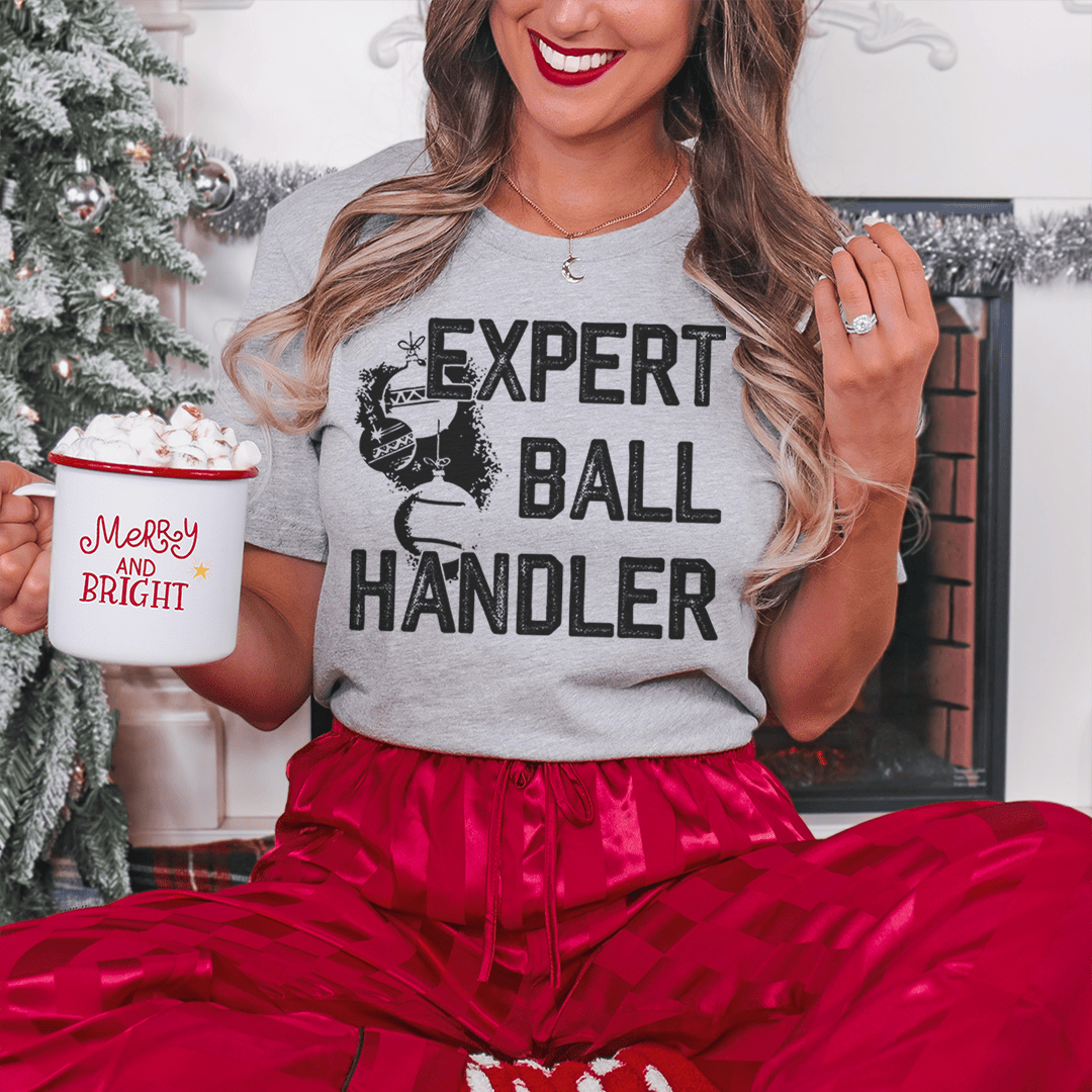 Expert Ball Handler Christmas Tee featuring a festive design, made from 100% soft cotton, perfect for holiday celebrations.