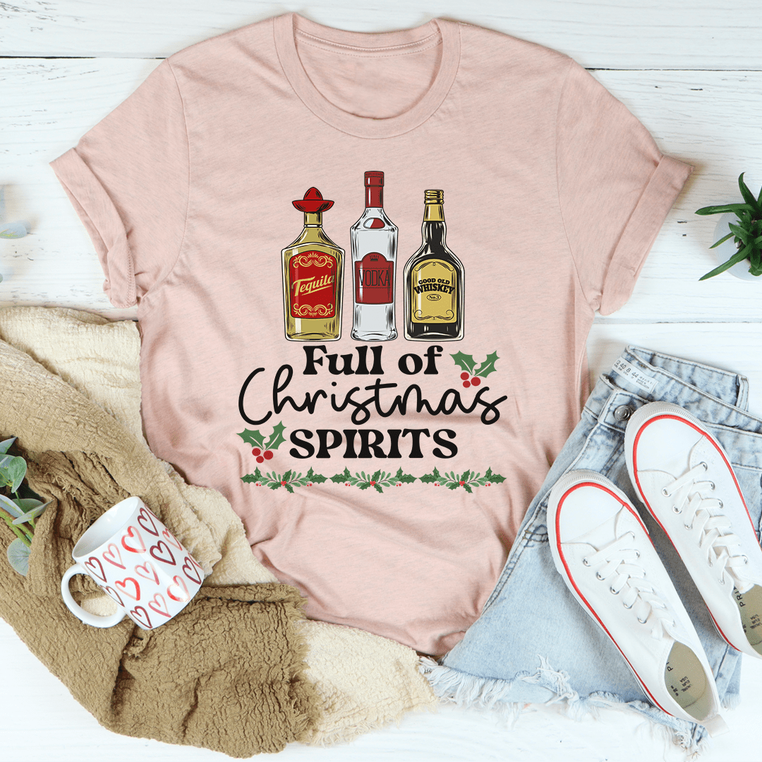 A festive Full Of Christmas Spirits Tee featuring a vibrant holiday-themed design, made from 100% soft cotton.