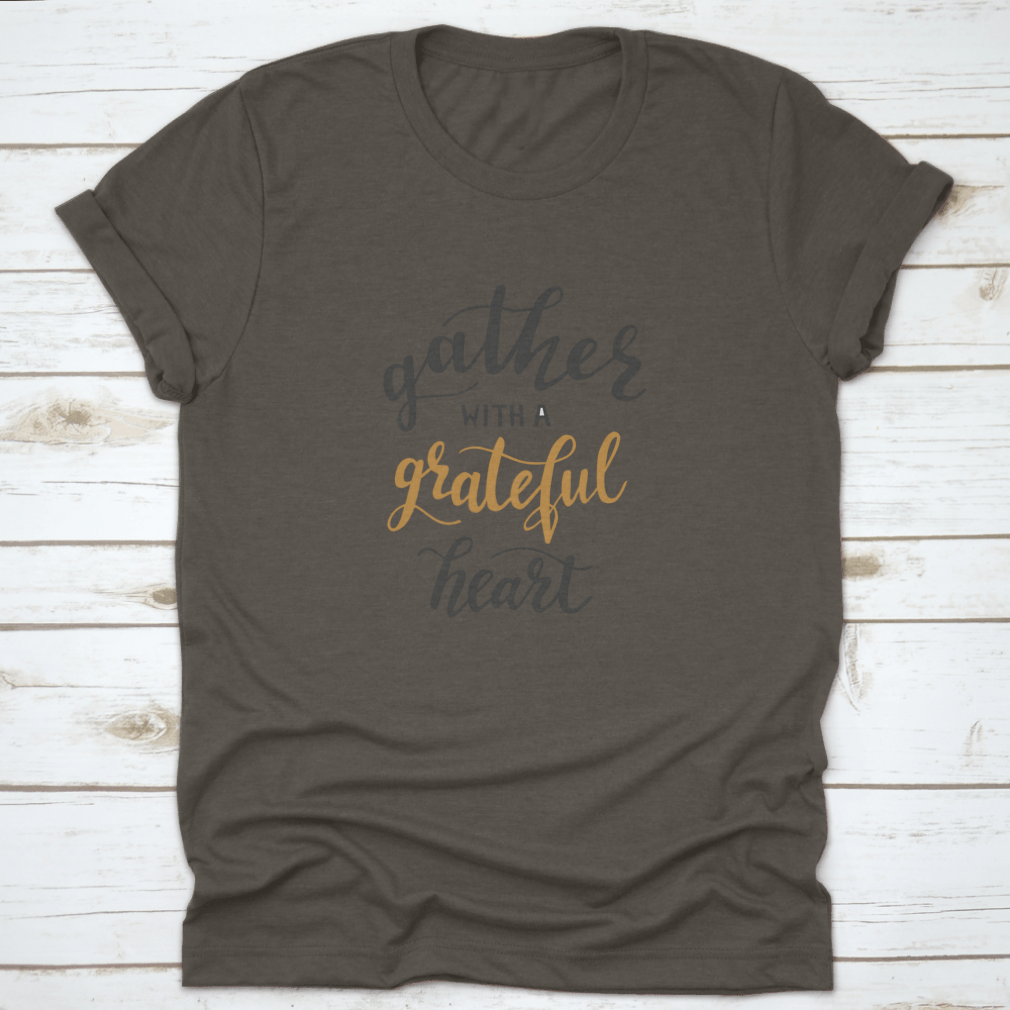 A comfortable t-shirt featuring the motivational quote 'Gather With A Grateful Heart' in an inspiring design, perfect for casual wear.