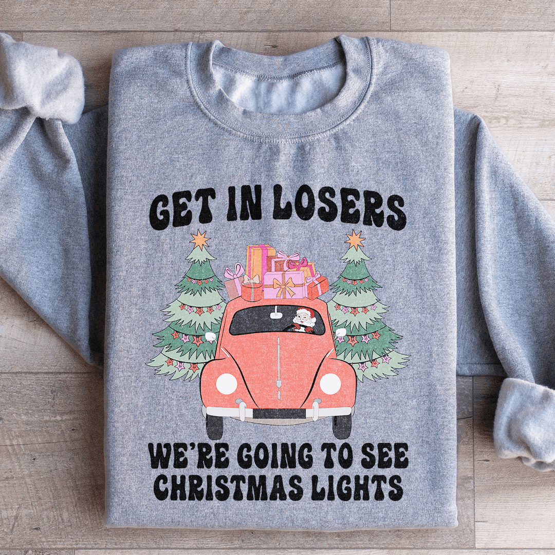 Cozy hoodie featuring the phrase 'Get In Losers We're Going To See Christmas Lights', designed by top artists, perfect for winter outings.
