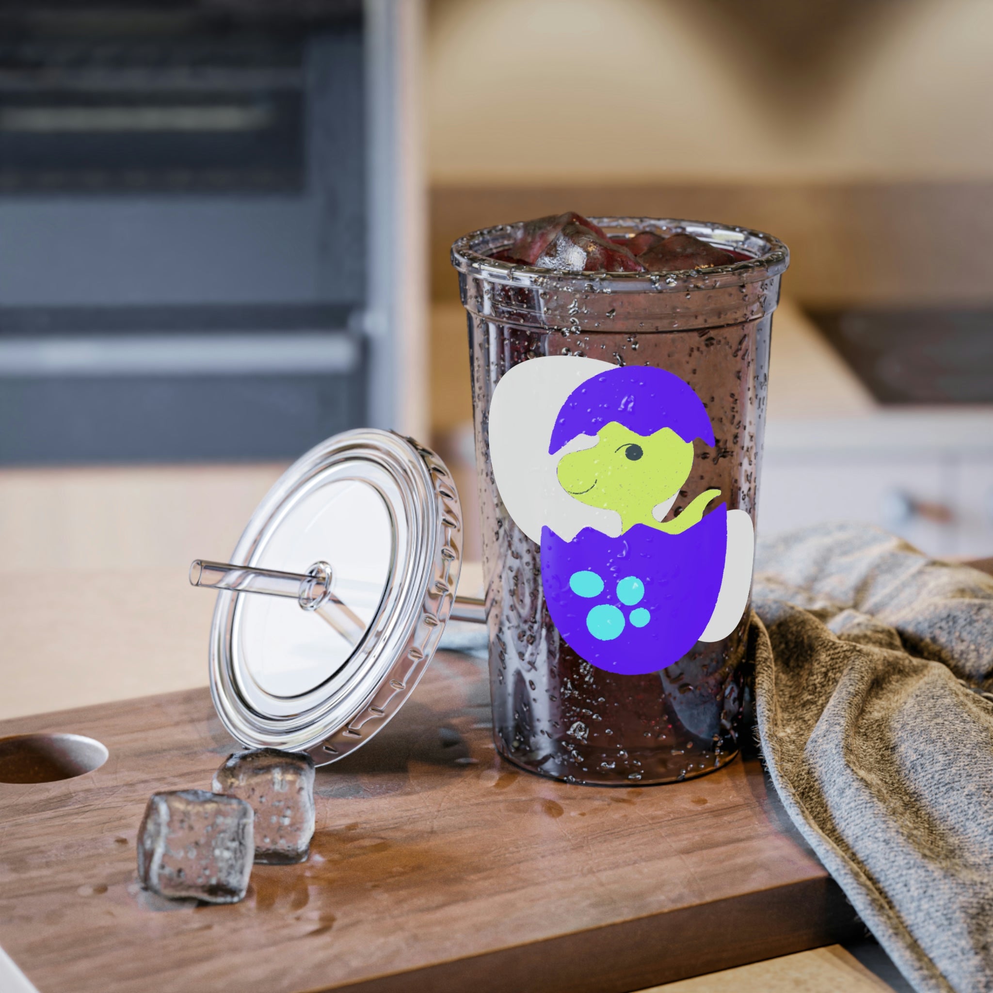 A vibrant green and purple dinosaur egg acrylic cup with a straw, showcasing a playful design perfect for beverages.