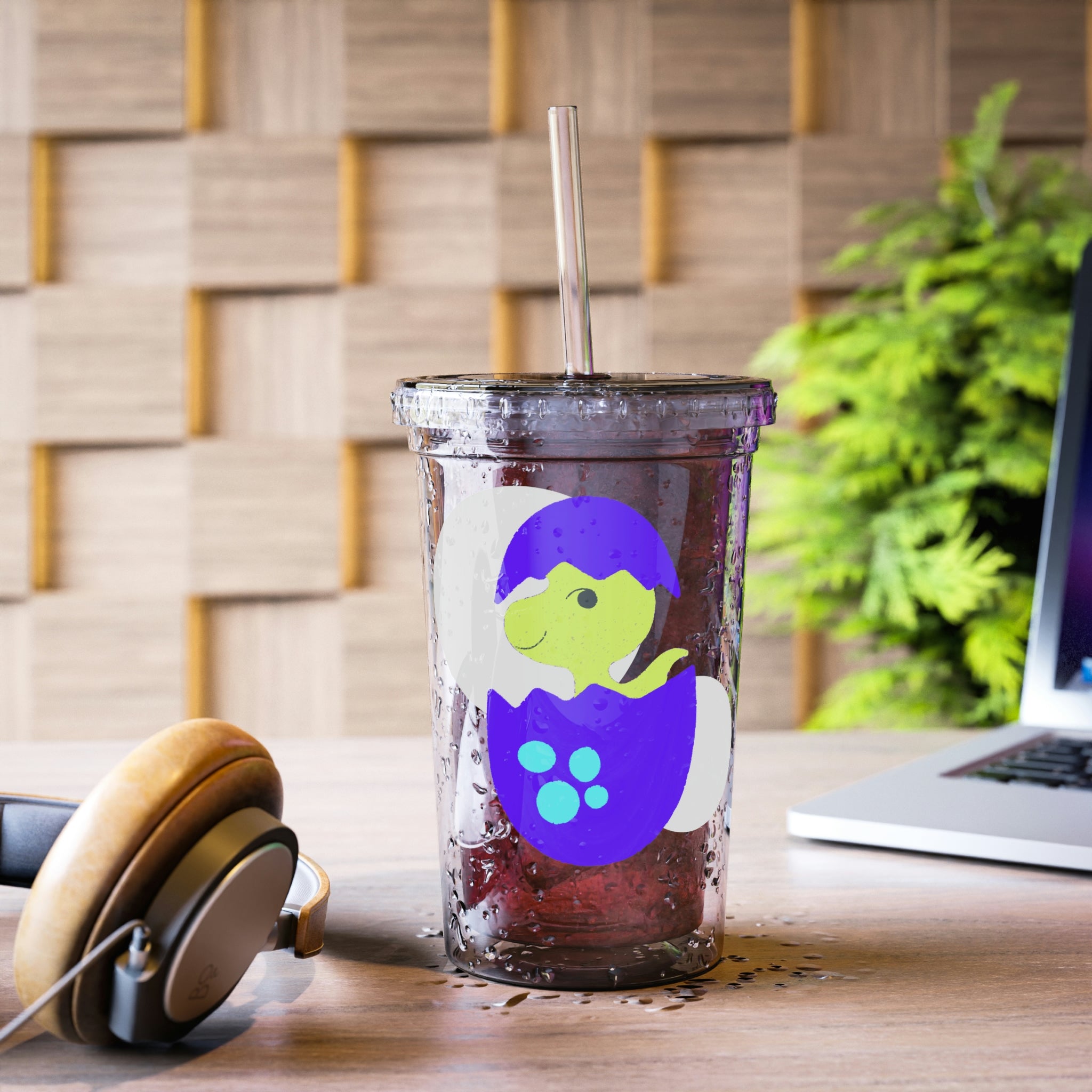 A vibrant green and purple dinosaur egg acrylic cup with a straw, showcasing a playful design perfect for beverages.