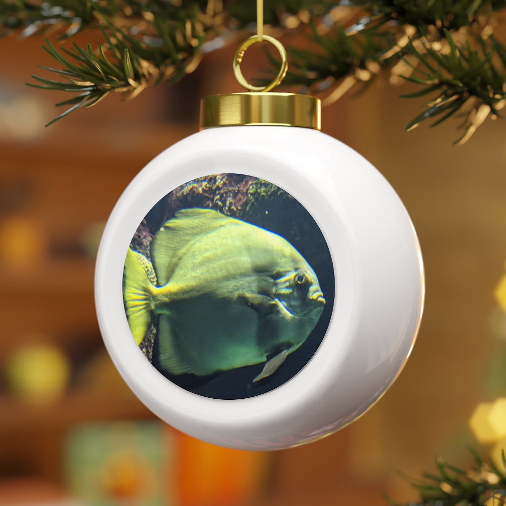 A beautiful green fish-themed Christmas ball ornament with a glossy finish and gold ribbon, perfect for holiday decorating.