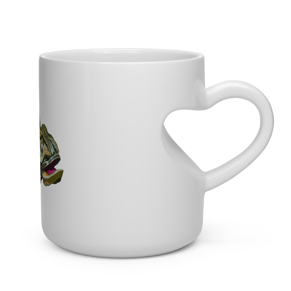 A white ceramic mug shaped like a heart with a green fish design, featuring a comfortable heart-shaped handle.