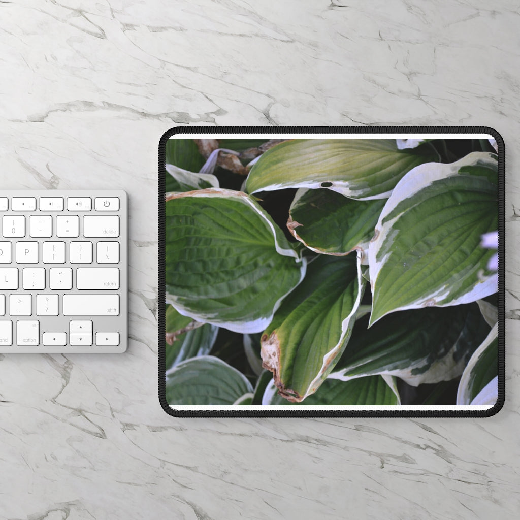 Green Leaves Gaming Mouse Pad featuring vibrant leaf designs and stitched edges, perfect for gaming and office use.