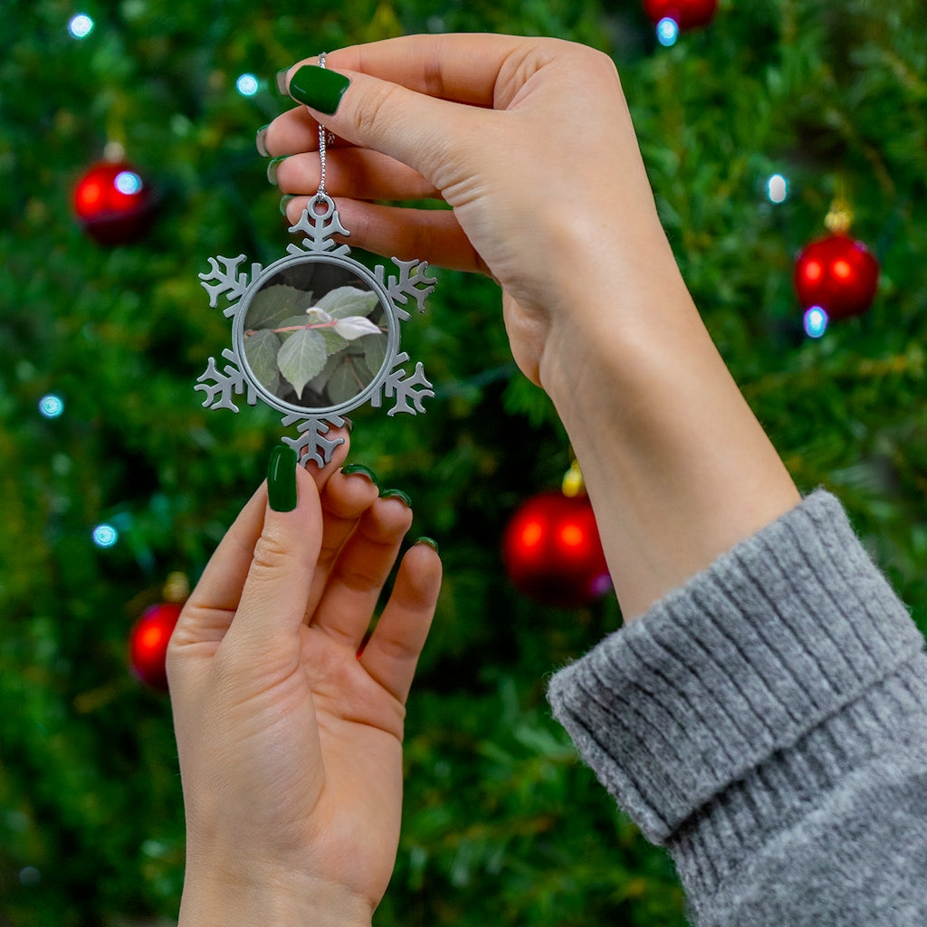 Green Leaves Pewter Snowflake Ornament with silver-toned hanging string, showcasing intricate snowflake design.