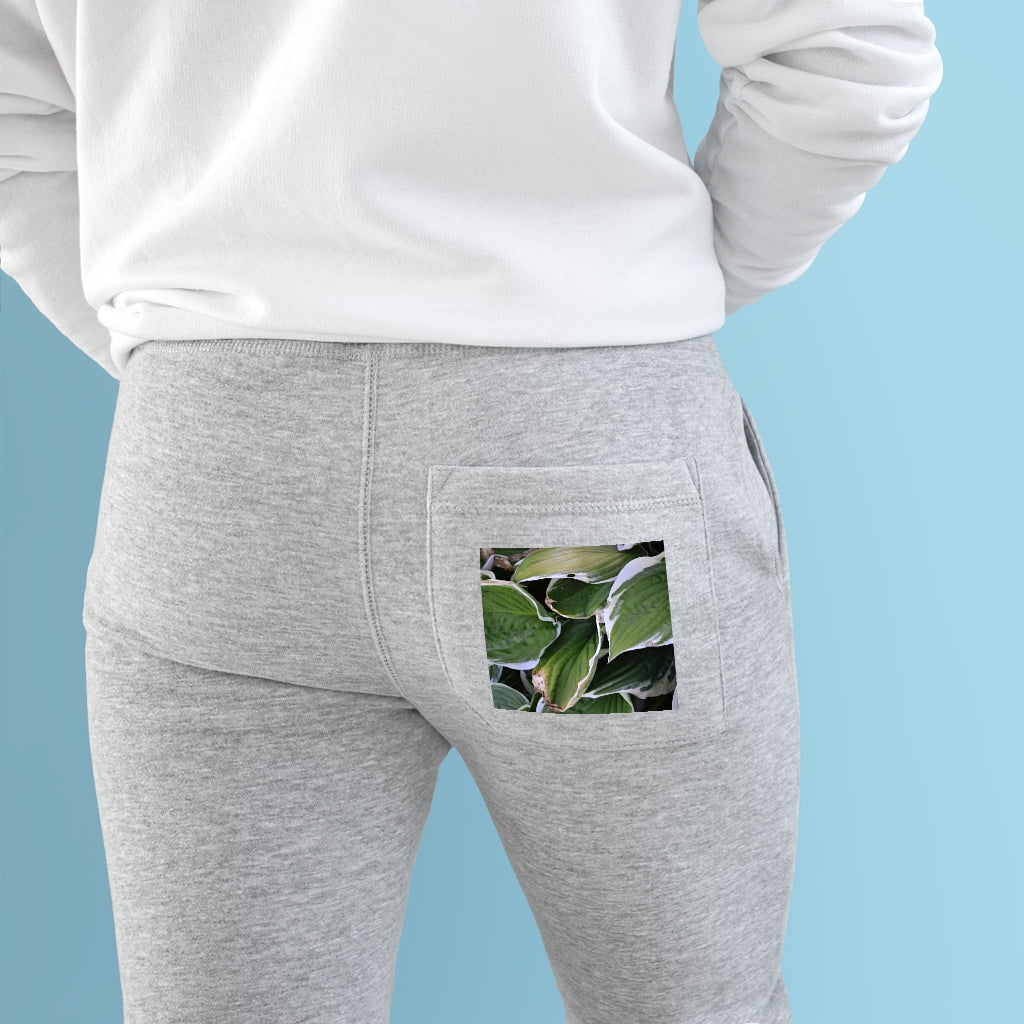 A pair of Green Leaves Premium Fleece Joggers showcasing a stylish design with two side pockets and a customizable back pocket.