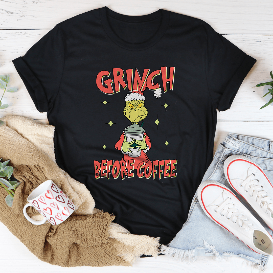 Grinch Before Coffee Tee featuring a festive design, made from 100% soft cotton, perfect for holiday celebrations.