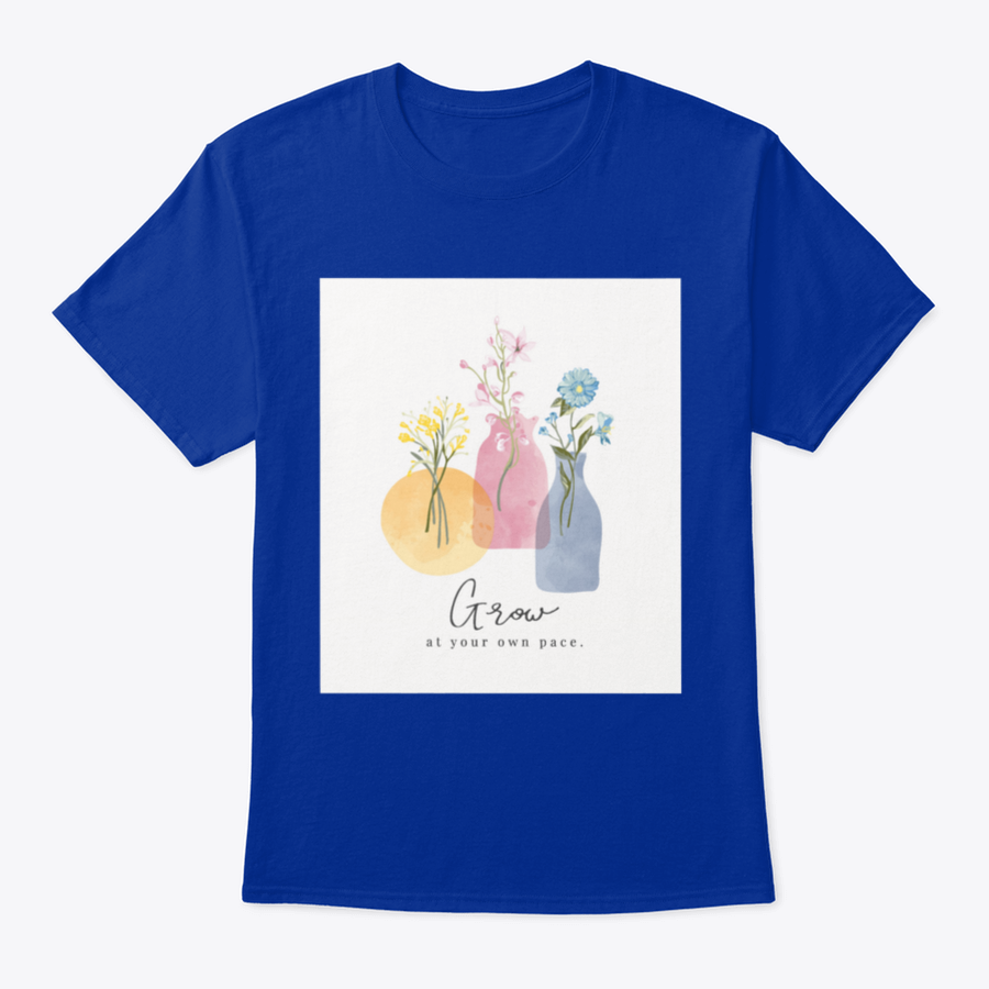 A colorful t-shirt featuring the slogan 'Grow At Your Own Pace' with a watercolor flower vase design, showcasing vibrant floral patterns.
