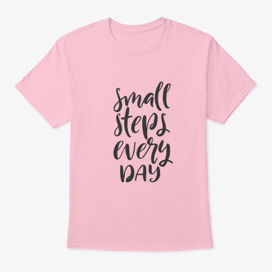 A stylish t-shirt featuring hand-drawn brush pen lettering with the phrase 'Small Steps Every', showcasing its comfortable fit and quality fabric.