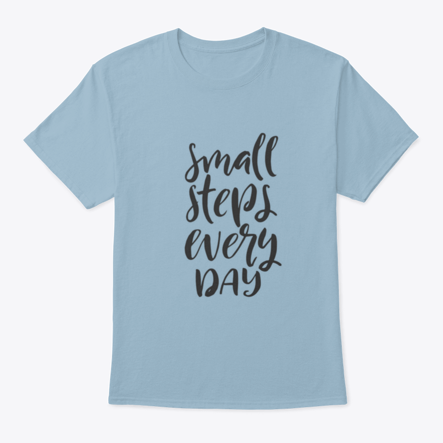 A stylish t-shirt featuring hand-drawn brush pen lettering with the phrase 'Small Steps Every', showcasing its comfortable fit and quality fabric.