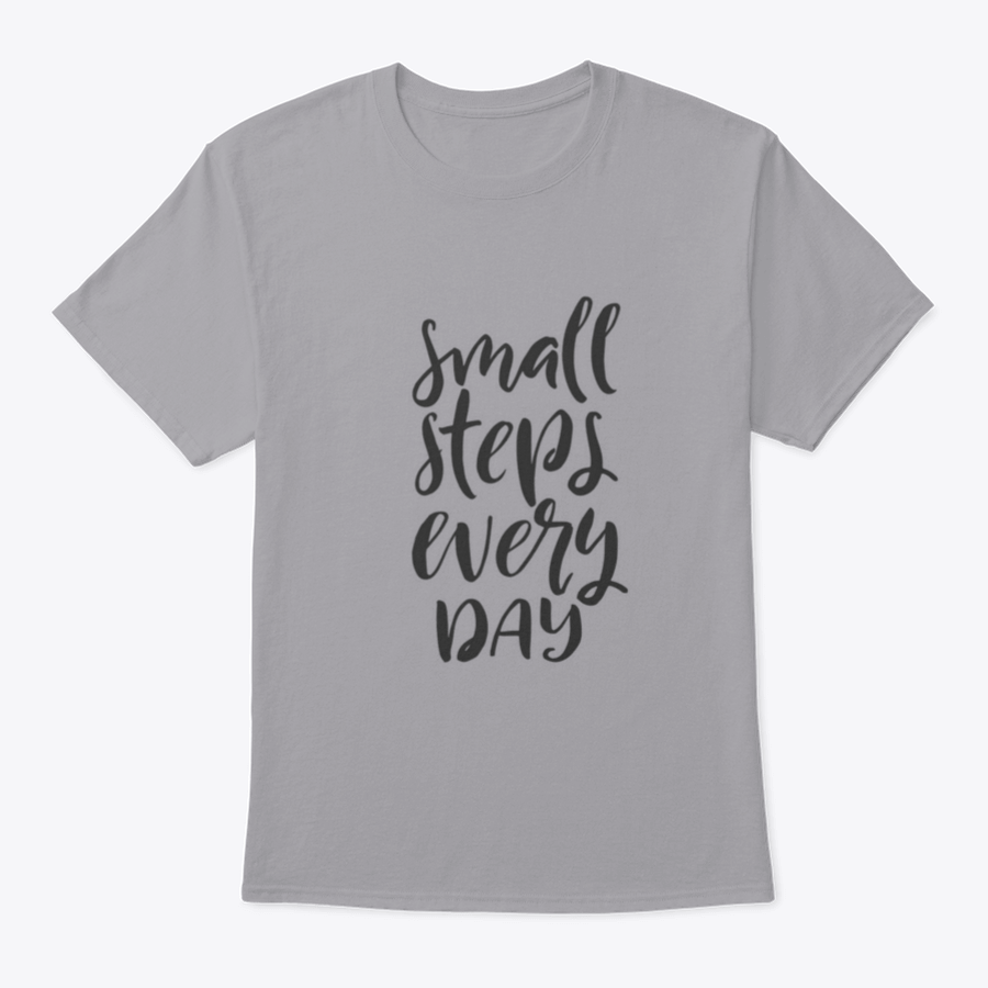A stylish t-shirt featuring hand-drawn brush pen lettering with the phrase 'Small Steps Every', showcasing its comfortable fit and quality fabric.