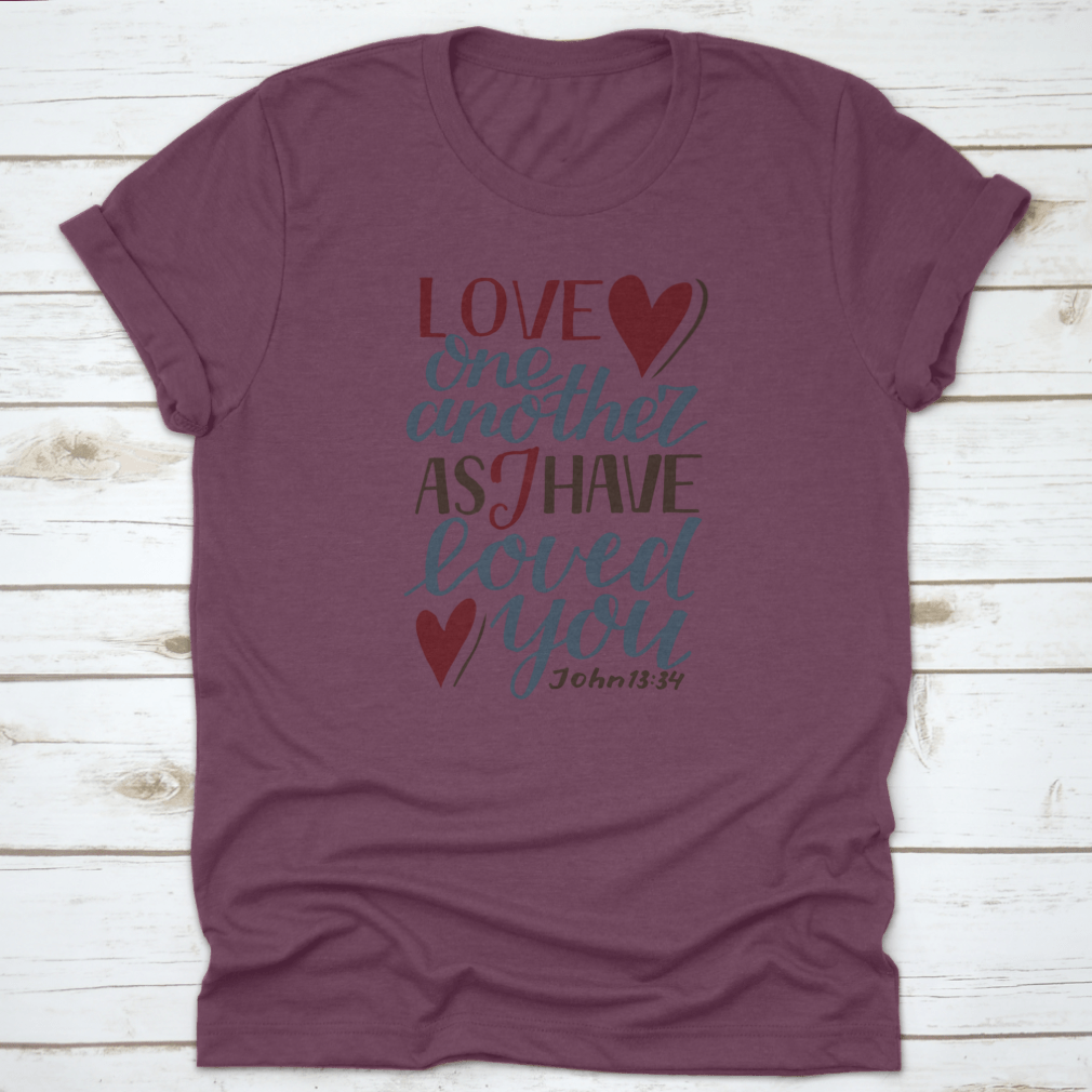 A stylish Hand Lettering Love One Another shirt featuring a modern biblical design, made from soft cotton fabric, perfect for expressing faith and love.