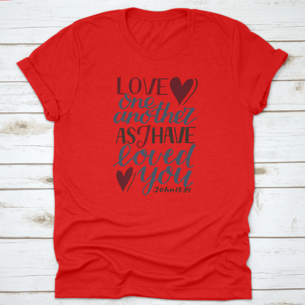 A stylish Hand Lettering Love One Another shirt featuring a modern biblical design, made from soft cotton fabric, perfect for expressing faith and love.