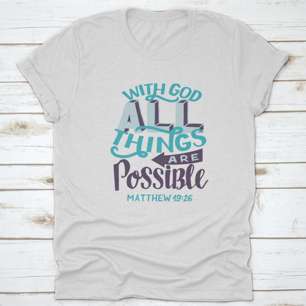 A stylish t-shirt featuring hand lettering of the Bible verse 'With God All Things Are Possible', showcasing a classic fit and soft fabric.