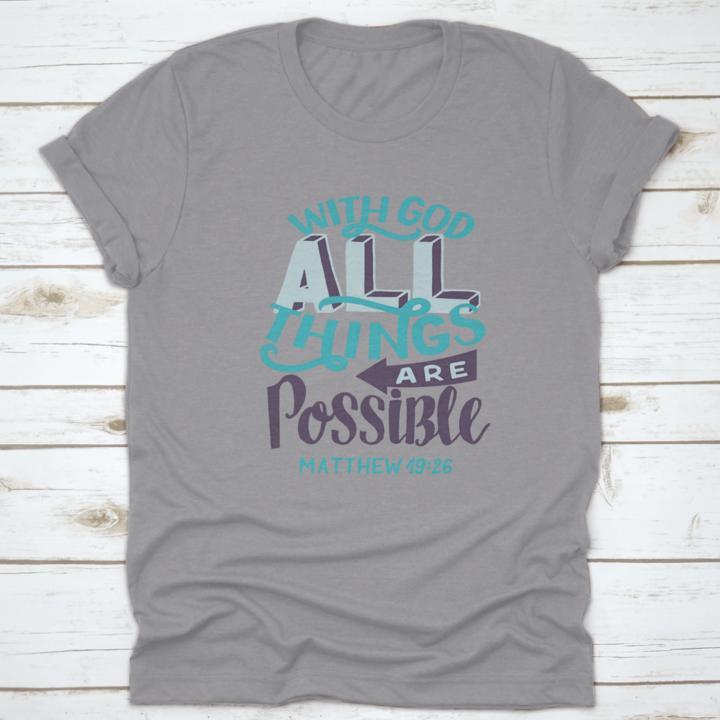 A stylish t-shirt featuring hand lettering of the Bible verse 'With God All Things Are Possible', showcasing a classic fit and soft fabric.