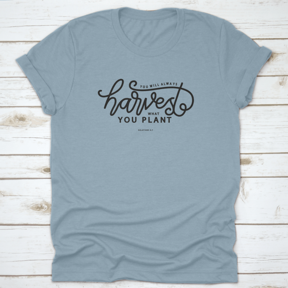 A stylish white t-shirt featuring hand lettering that says 'You Will Always Harvest What You Plant', showcasing its unique design and quality fabric.