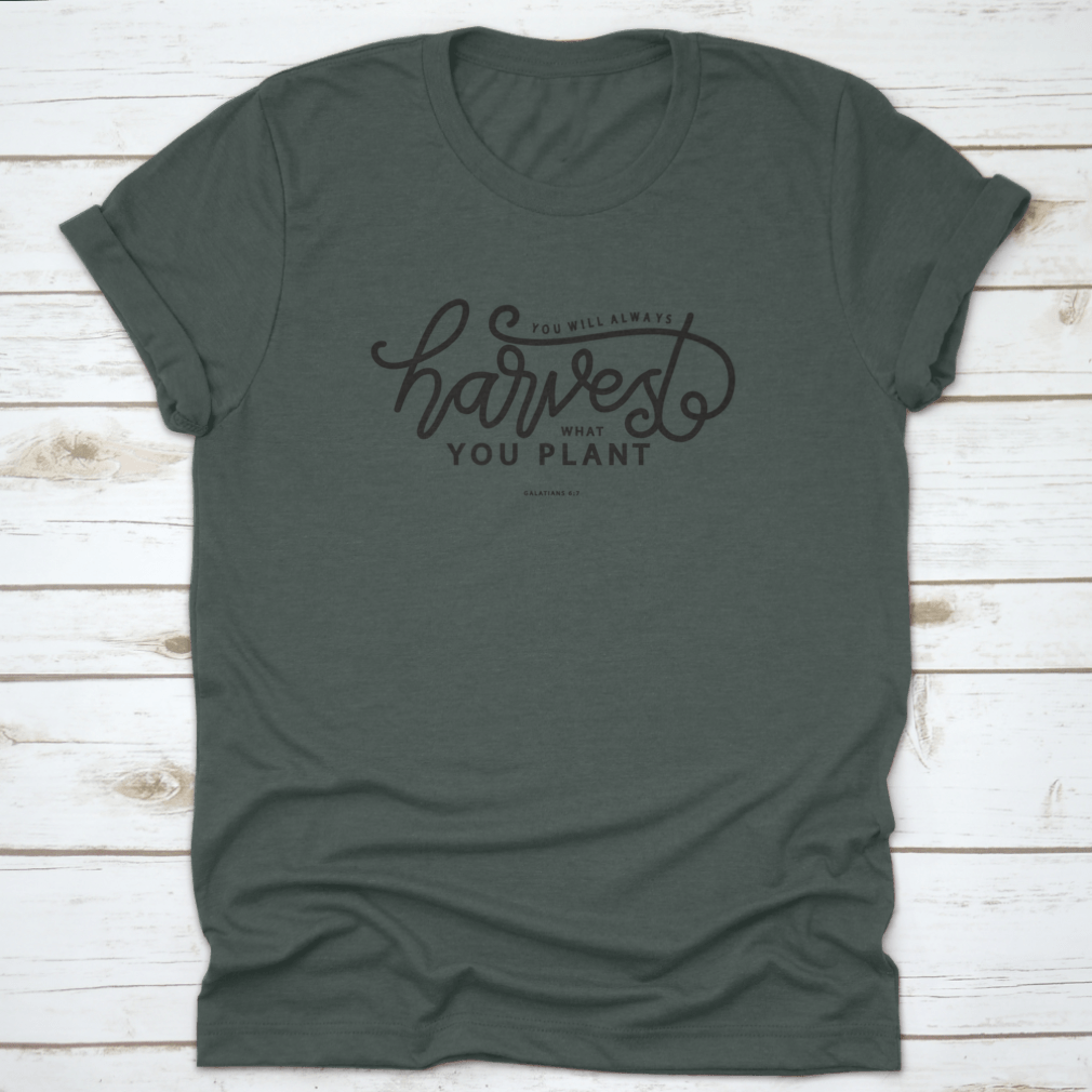 A stylish white t-shirt featuring hand lettering that says 'You Will Always Harvest What You Plant', showcasing its unique design and quality fabric.