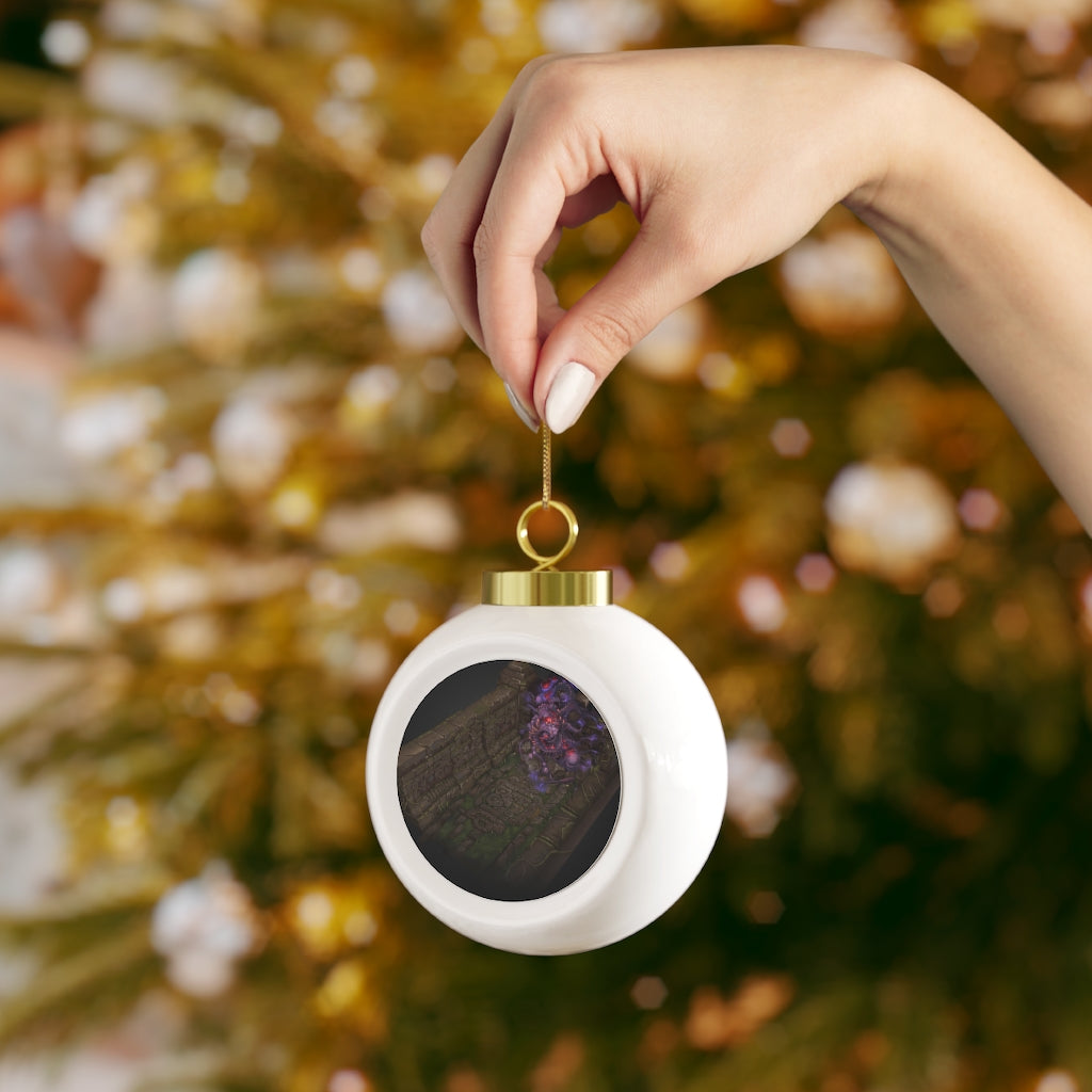 A beautifully hand-painted Christmas ball ornament featuring vibrant colors and a glossy finish, adorned with a gold ribbon for hanging.