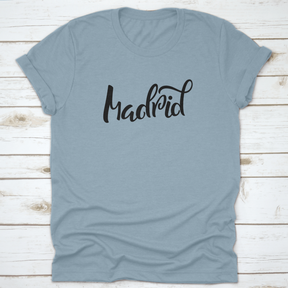 A stylish t-shirt featuring hand-lettered calligraphy of Madrid, showcasing vibrant colors and a comfortable fit.