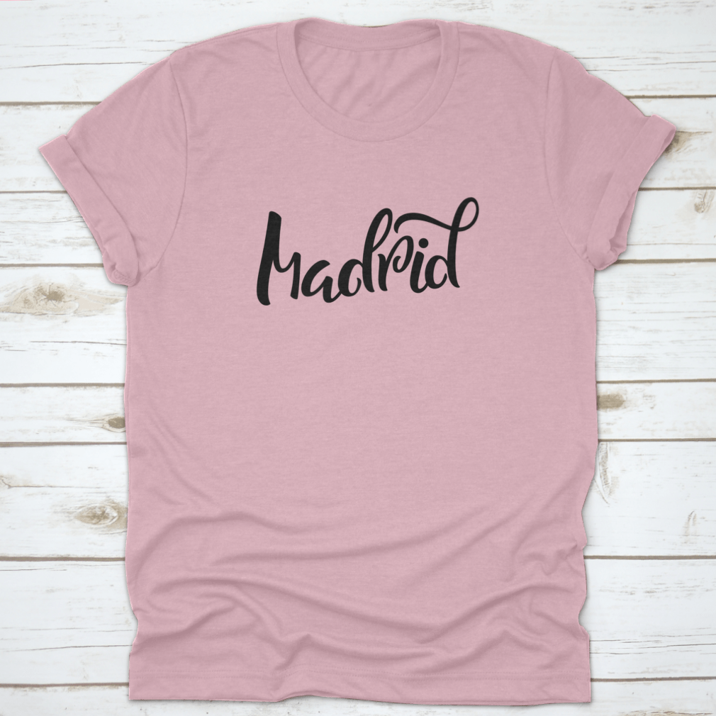 A stylish t-shirt featuring hand-lettered calligraphy of Madrid, showcasing vibrant colors and a comfortable fit.