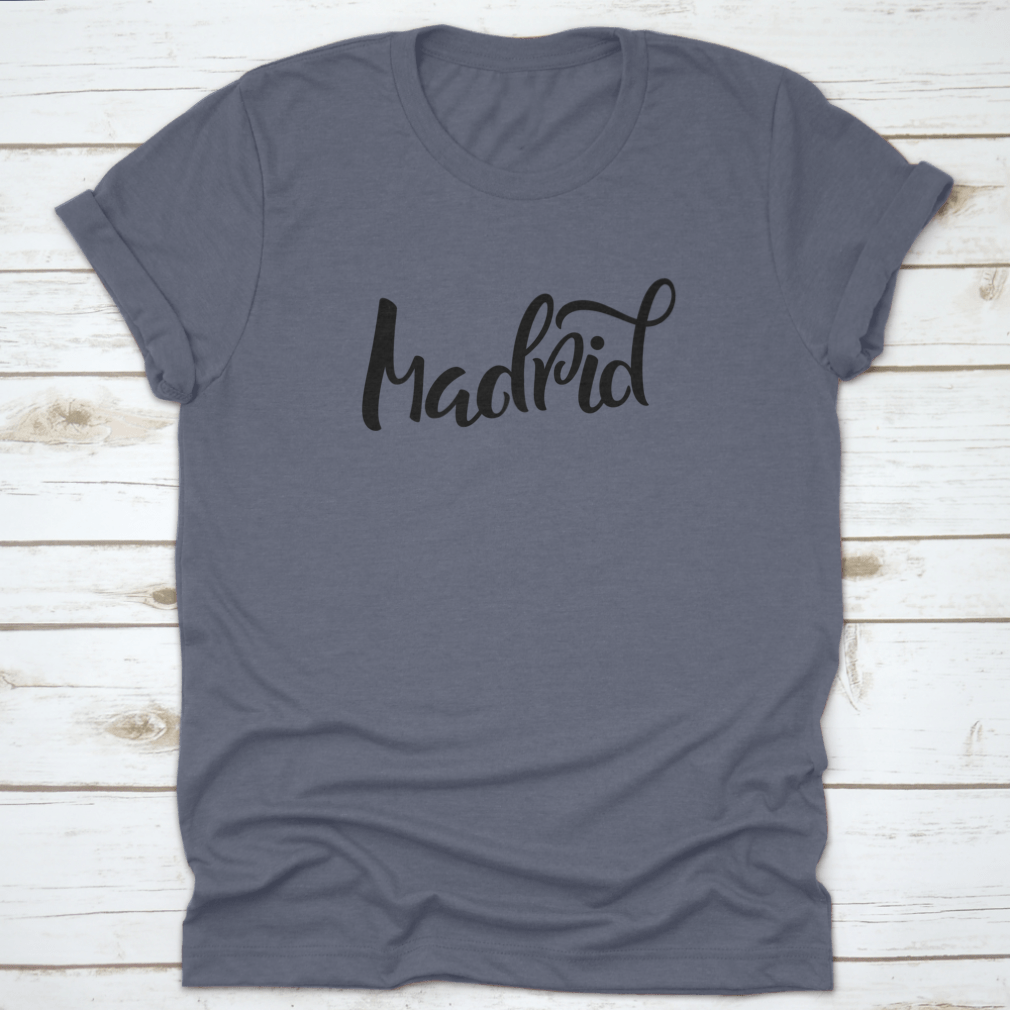 A stylish t-shirt featuring hand-lettered calligraphy of Madrid, showcasing vibrant colors and a comfortable fit.