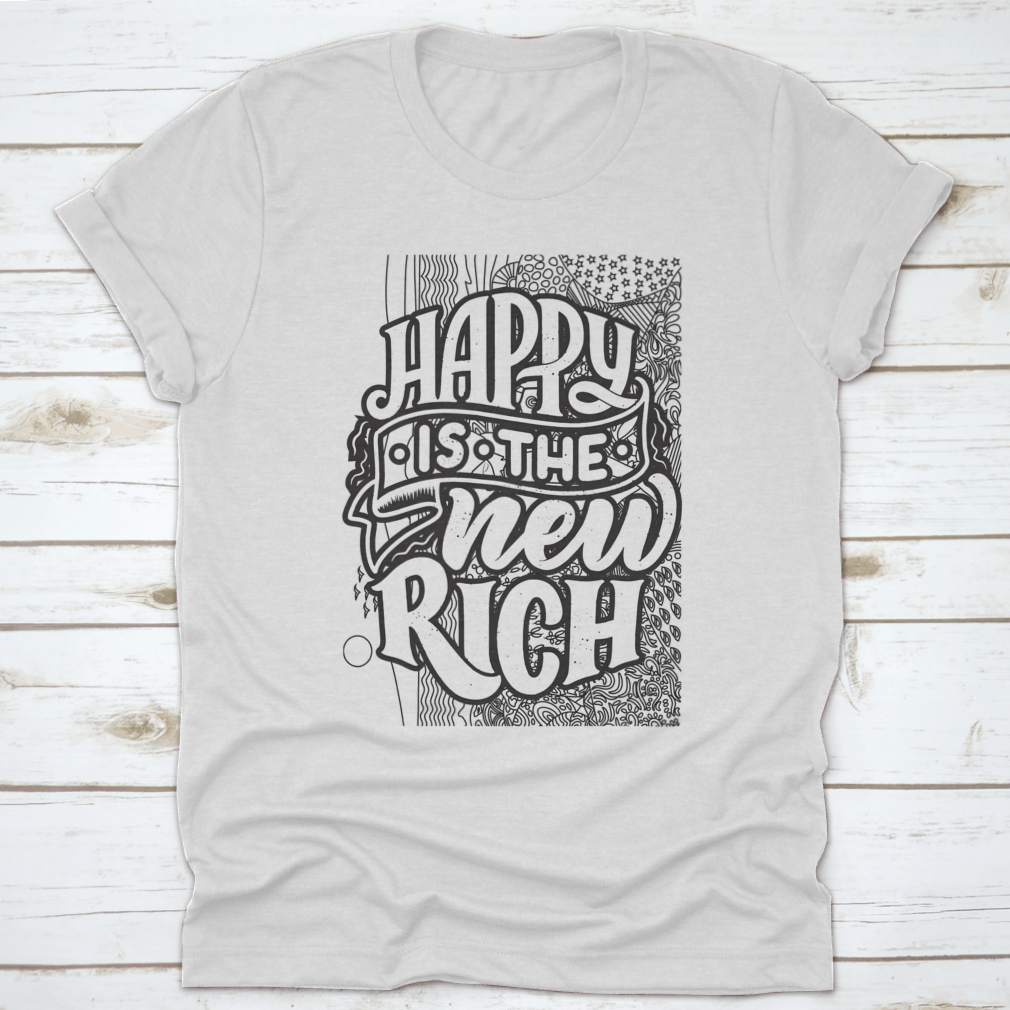 A soft cotton t-shirt featuring the inspirational phrase 'Happy Is The New Rich' in a stylish design, perfect for casual wear.