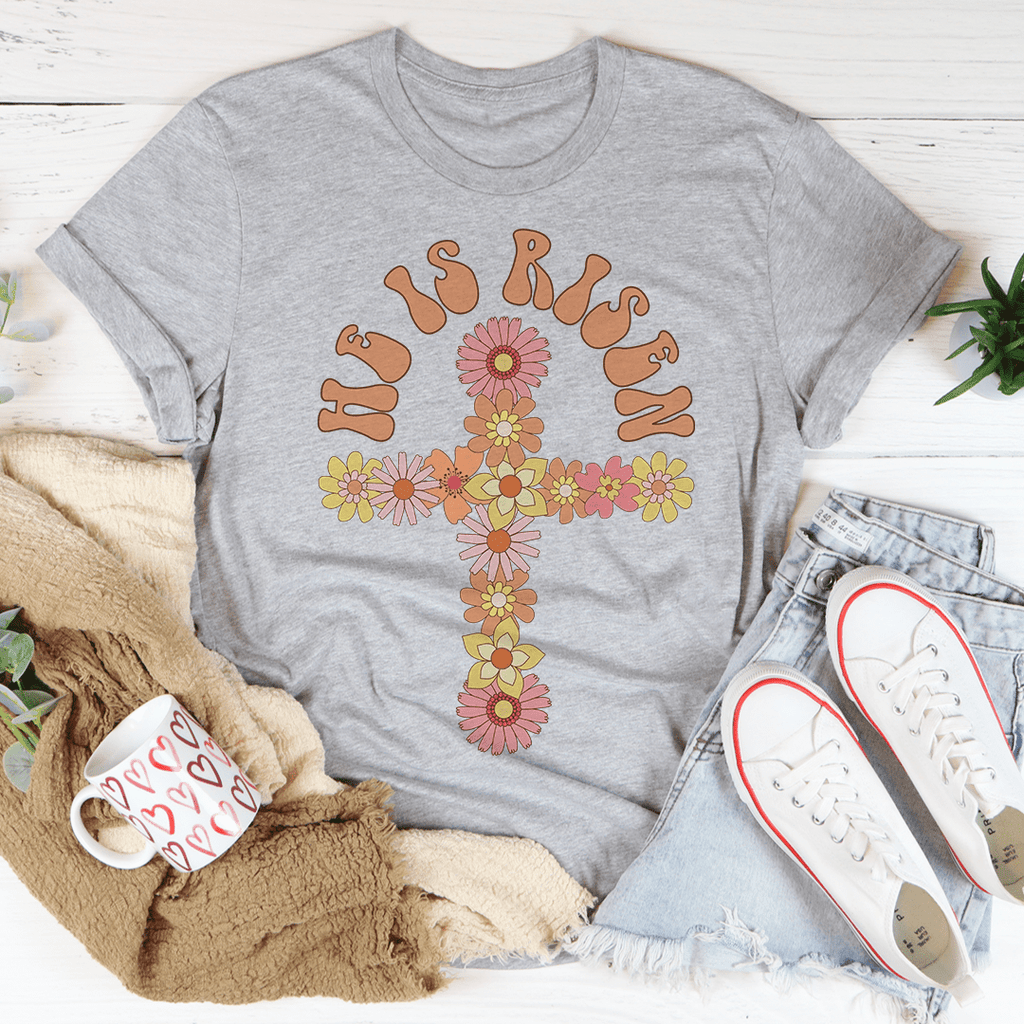 He Is Risen Floral Cross T-Shirt featuring a floral cross design on a soft cotton fabric, perfect for casual wear.