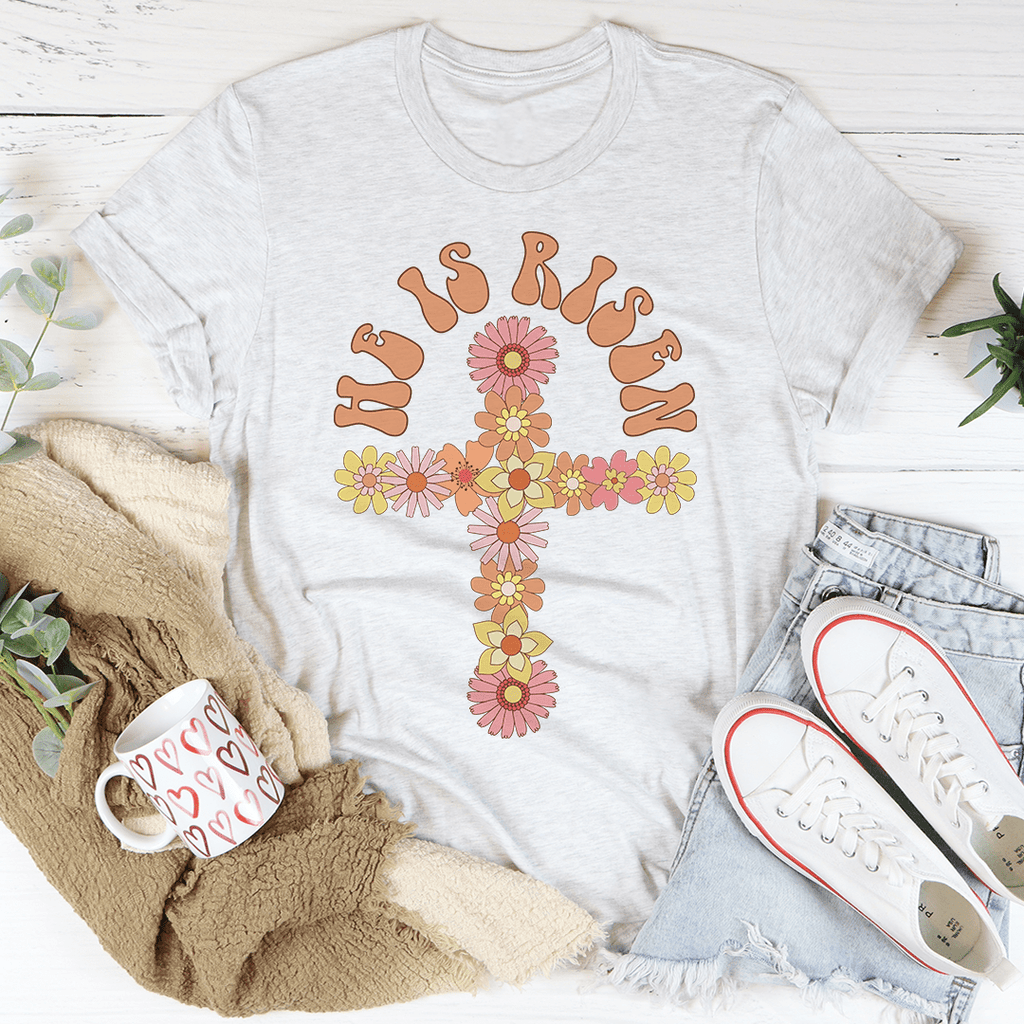 He Is Risen Floral Cross T-Shirt featuring a floral cross design on a soft cotton fabric, perfect for casual wear.