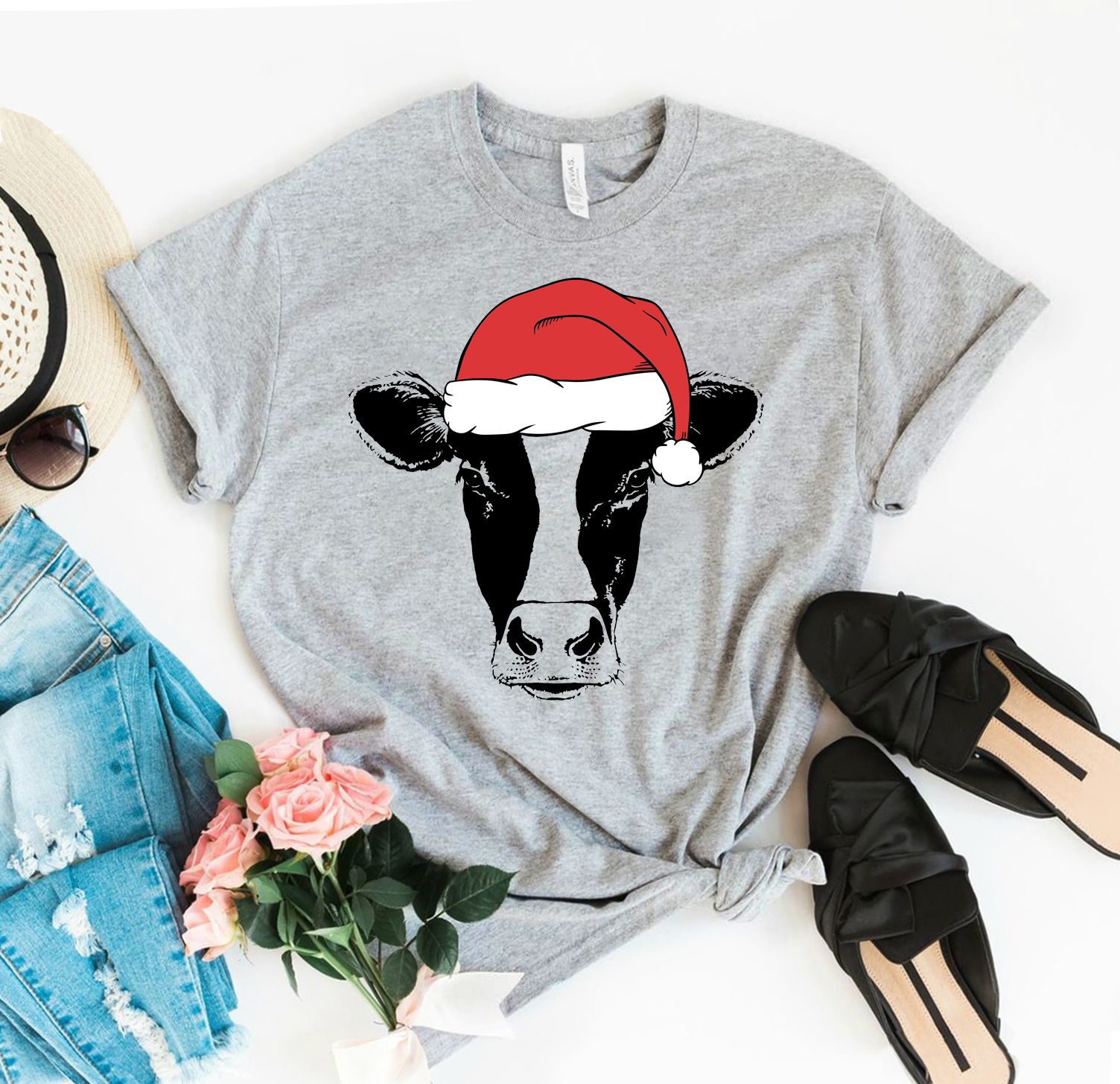 Heifer Santa Christmas T-shirt featuring a festive design, made from premium ring spun cotton, available in various sizes.