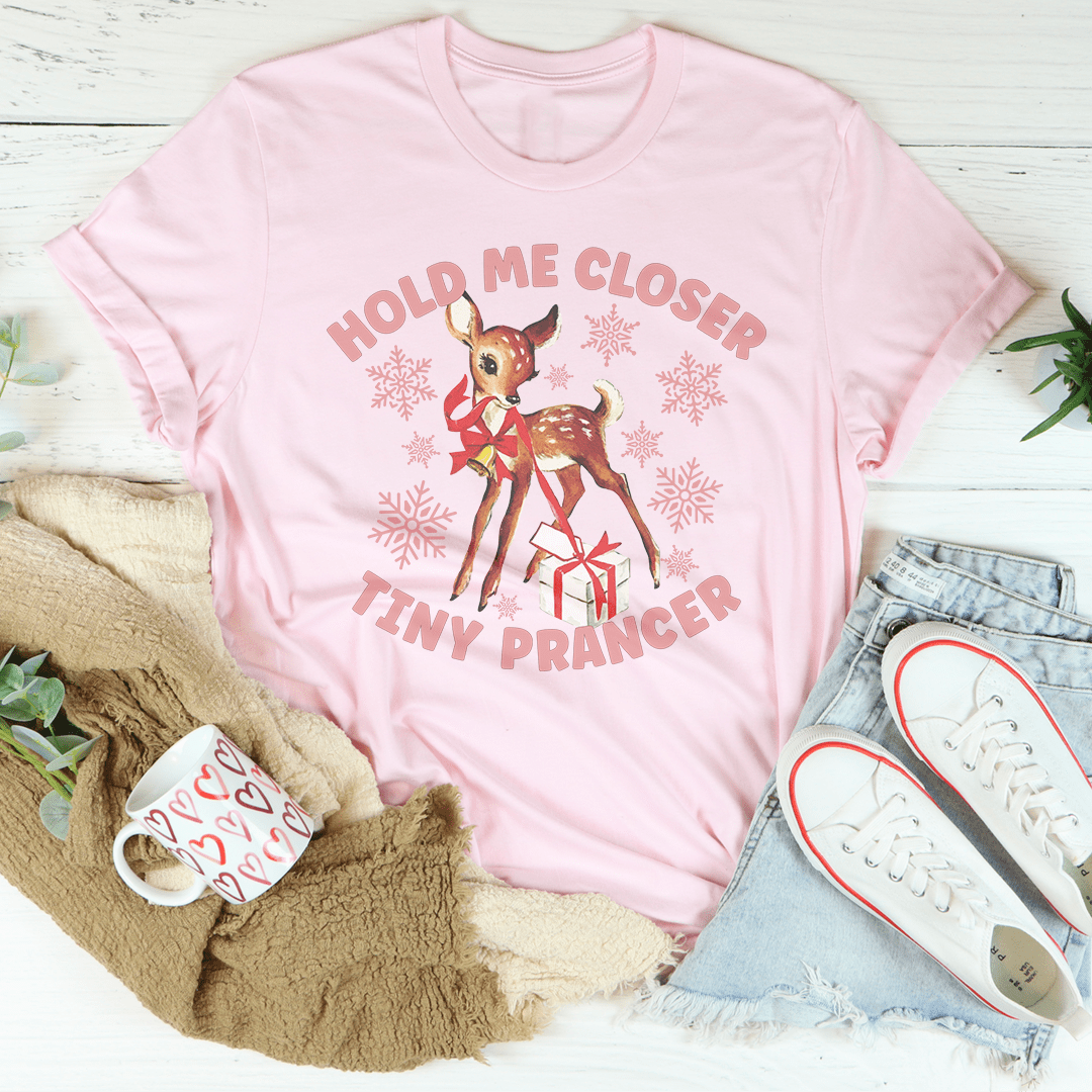 A festive Hold Me Closer Tiny Prancer Tee made from 100% soft cotton, featuring a vibrant Christmas-themed design, perfect for holiday celebrations.
