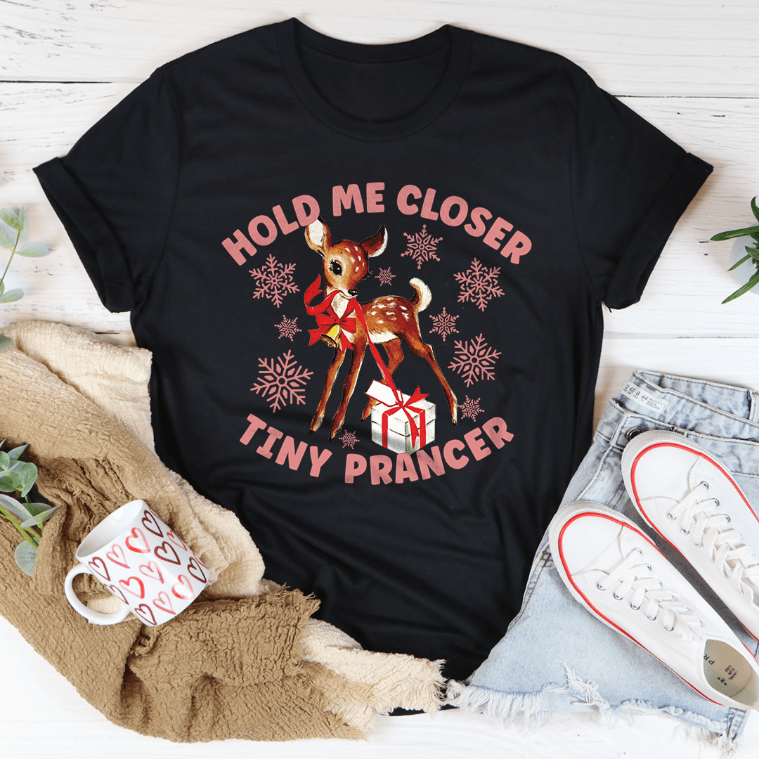 A festive Hold Me Closer Tiny Prancer Tee made from 100% soft cotton, featuring a vibrant Christmas-themed design, perfect for holiday celebrations.